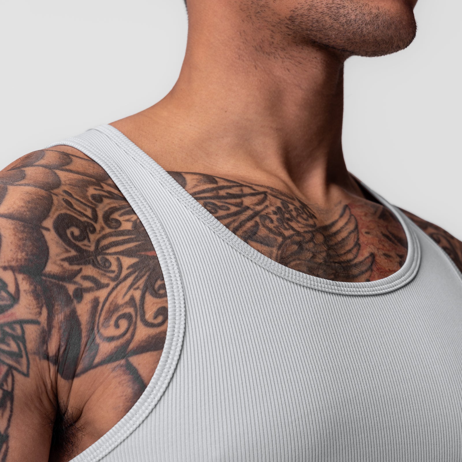 Creora® Tech Ribbed Tank in light grey worn by male model, side angle view