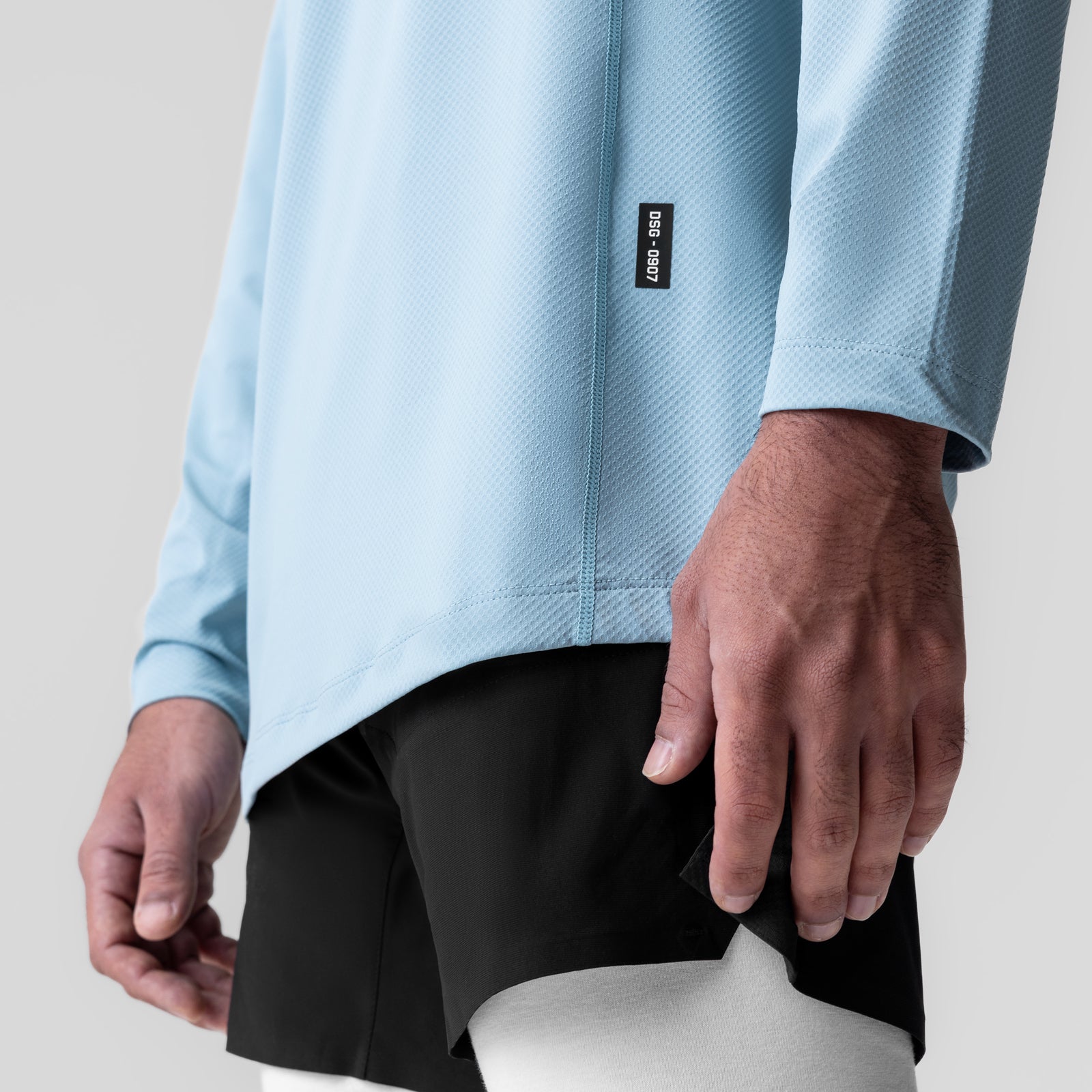 AeroSilver Training Long Sleeve in light sky worn by model, closeup of torso and sleeves