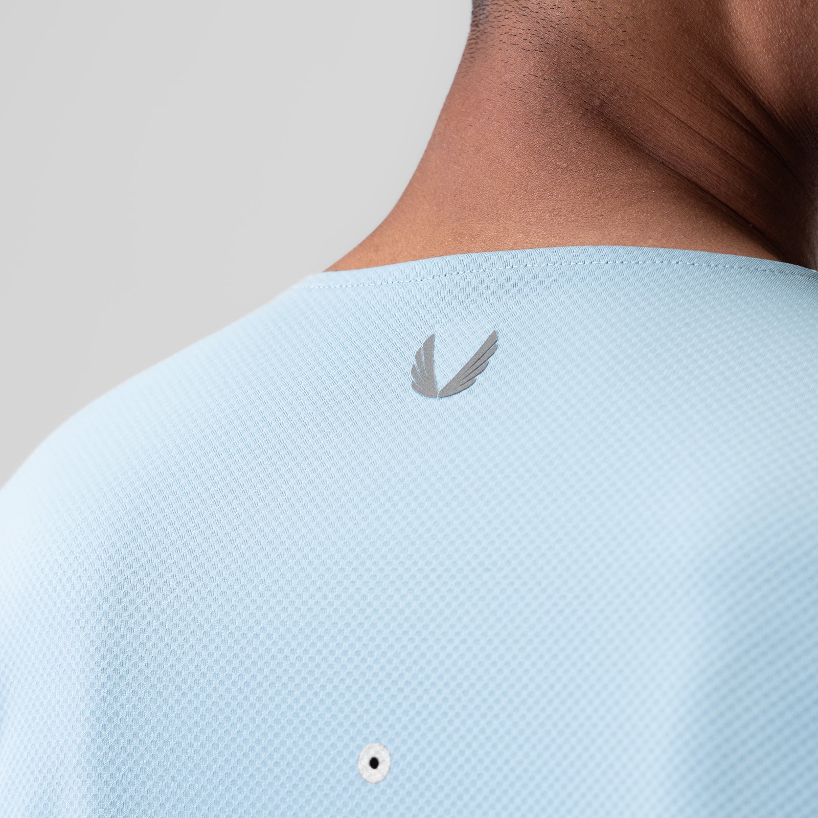 AeroSilver Training Long Sleeve in light sky worn on model, back view showing logo detail