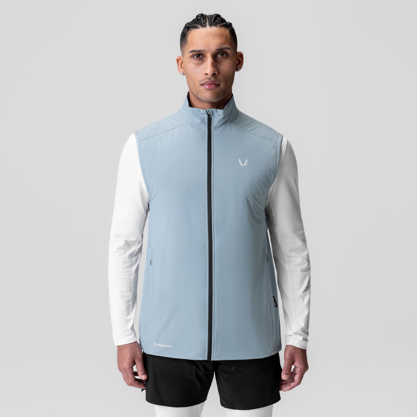 Aerotex PrimaLoft Run Vest in light sky, worn by model with white long-sleeve shirt and black shorts