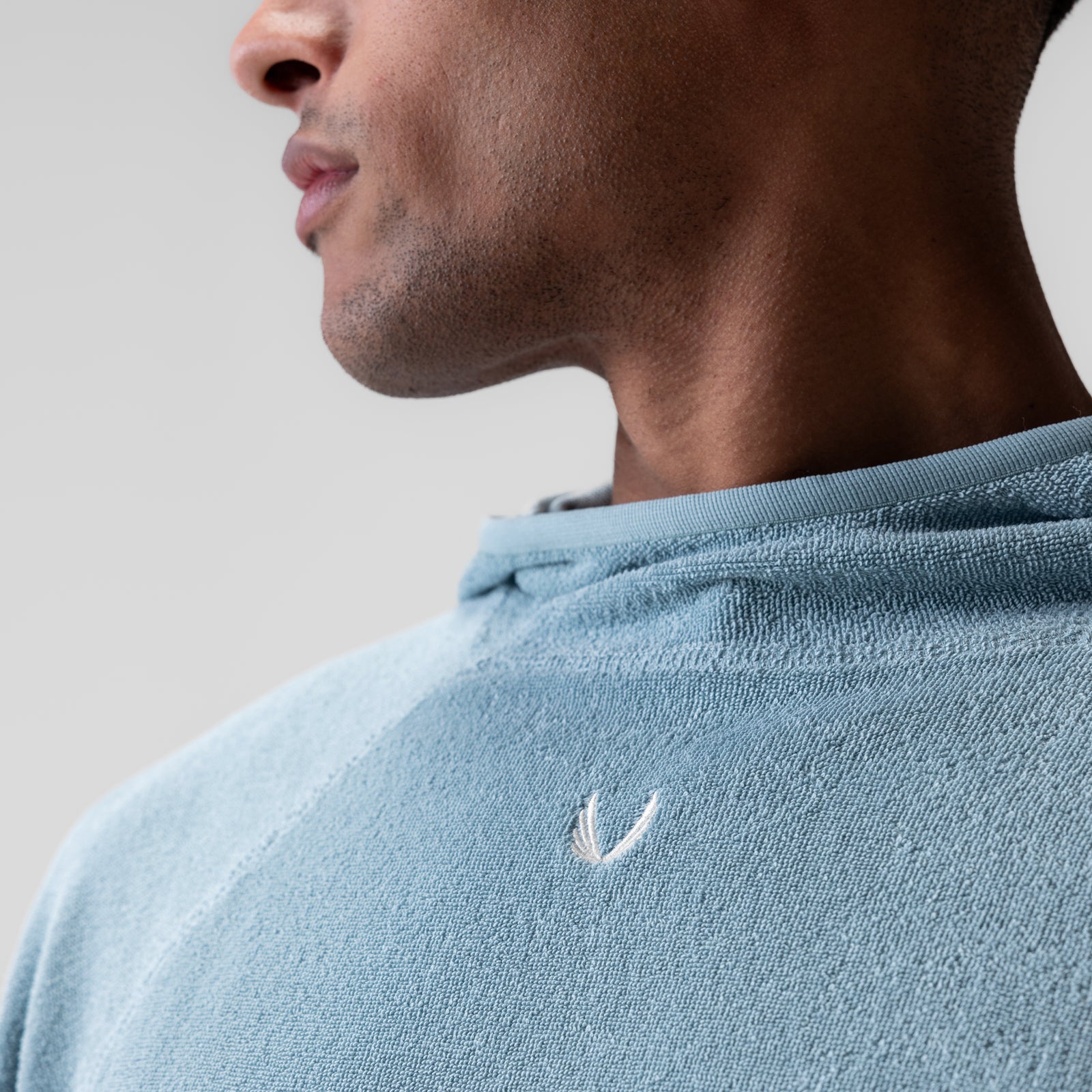 Towel Terry Reversible Hoodie in light sky, worn by model in profile view