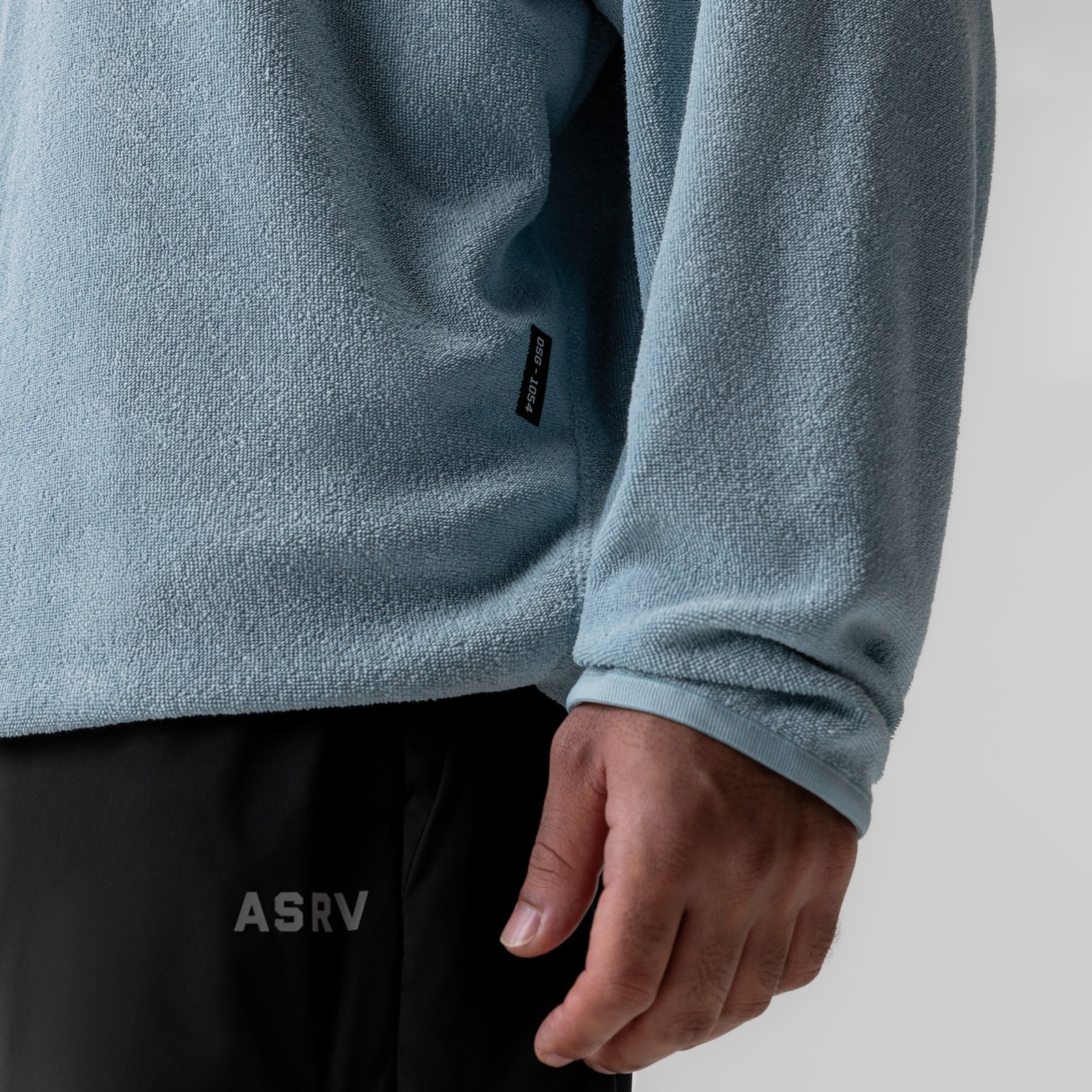 Towel Terry Reversible Hoodie in light sky worn by model, detail view of sleeve and torso