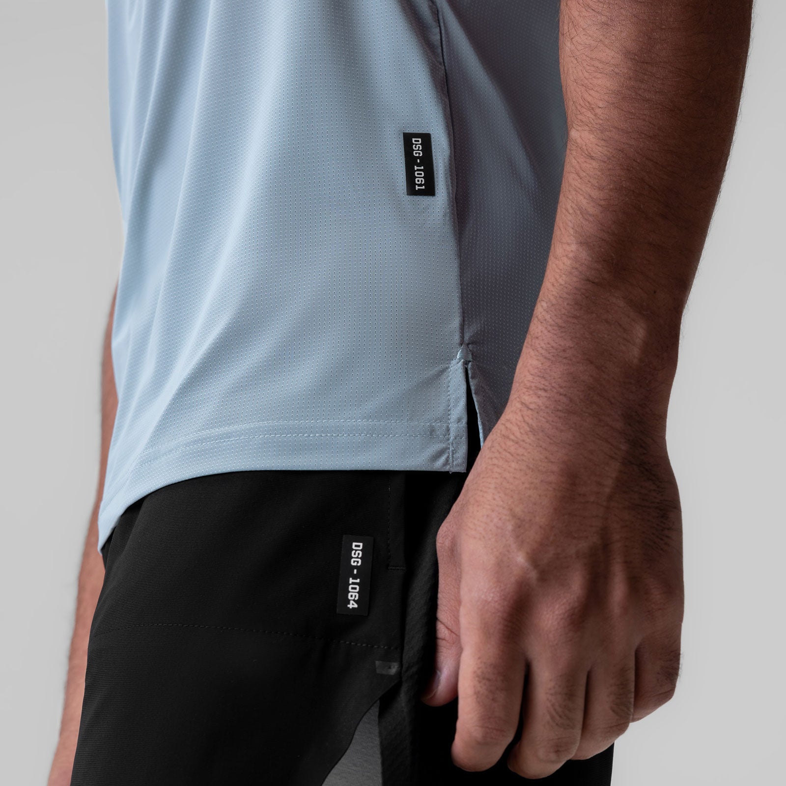 Ice-Skin™ Muscle Tank in light sky worn by model, side view showing fit and fabric