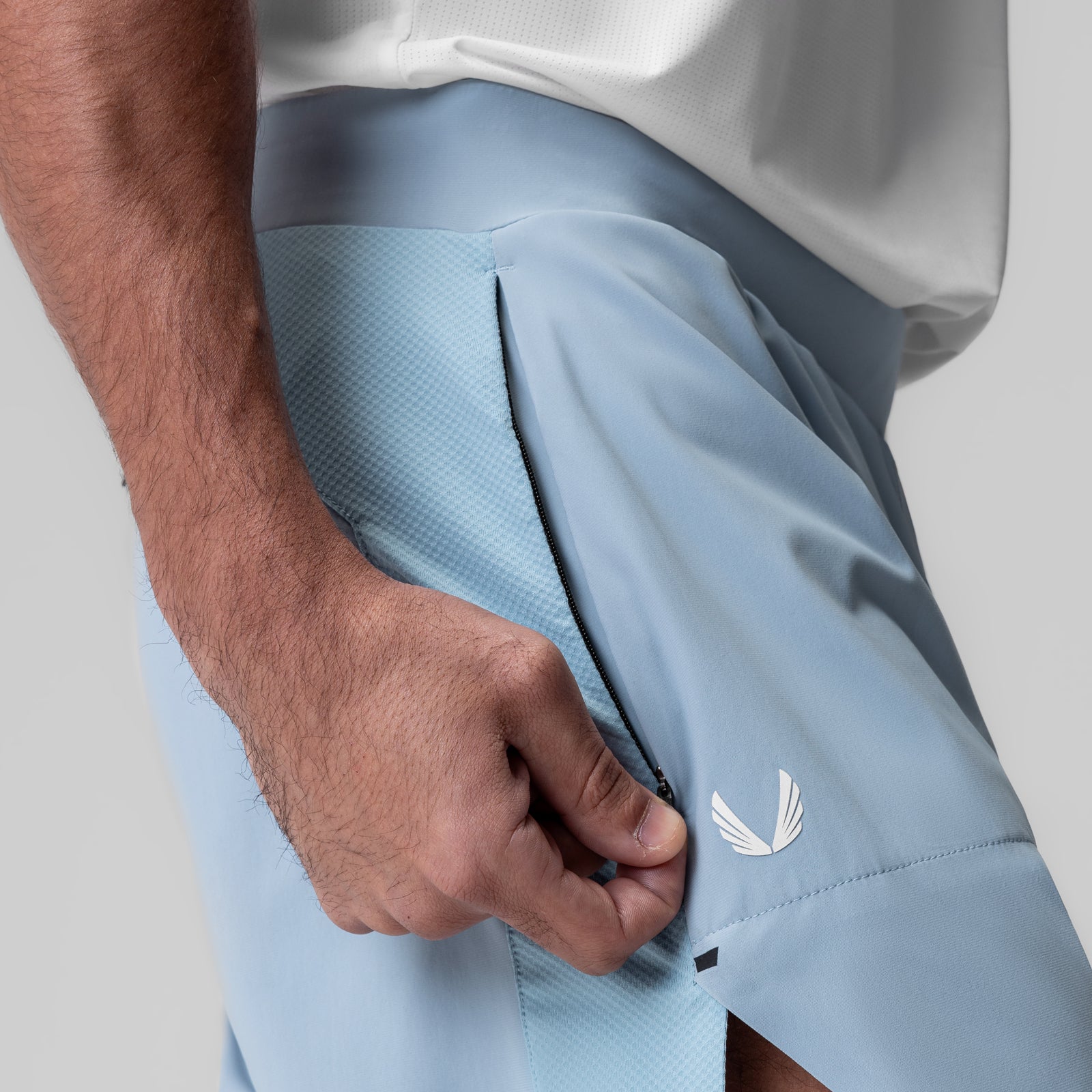 Tetra-Lite® 6" Bonded Training Short in light sky, worn by model with hand in pocket