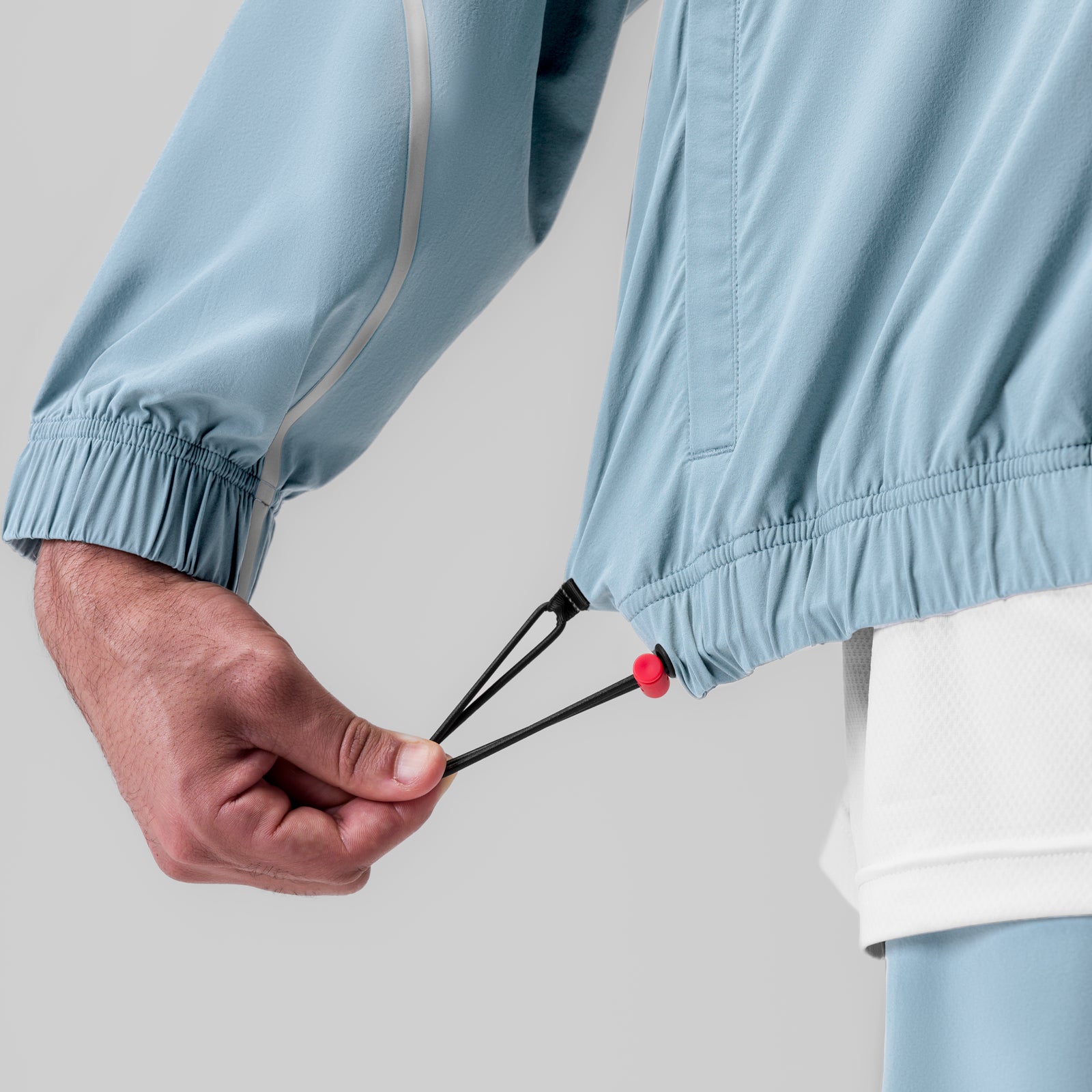 Aerotex™ Track Jacket in Light Sky, model wearing jacket with drawstring detail visible