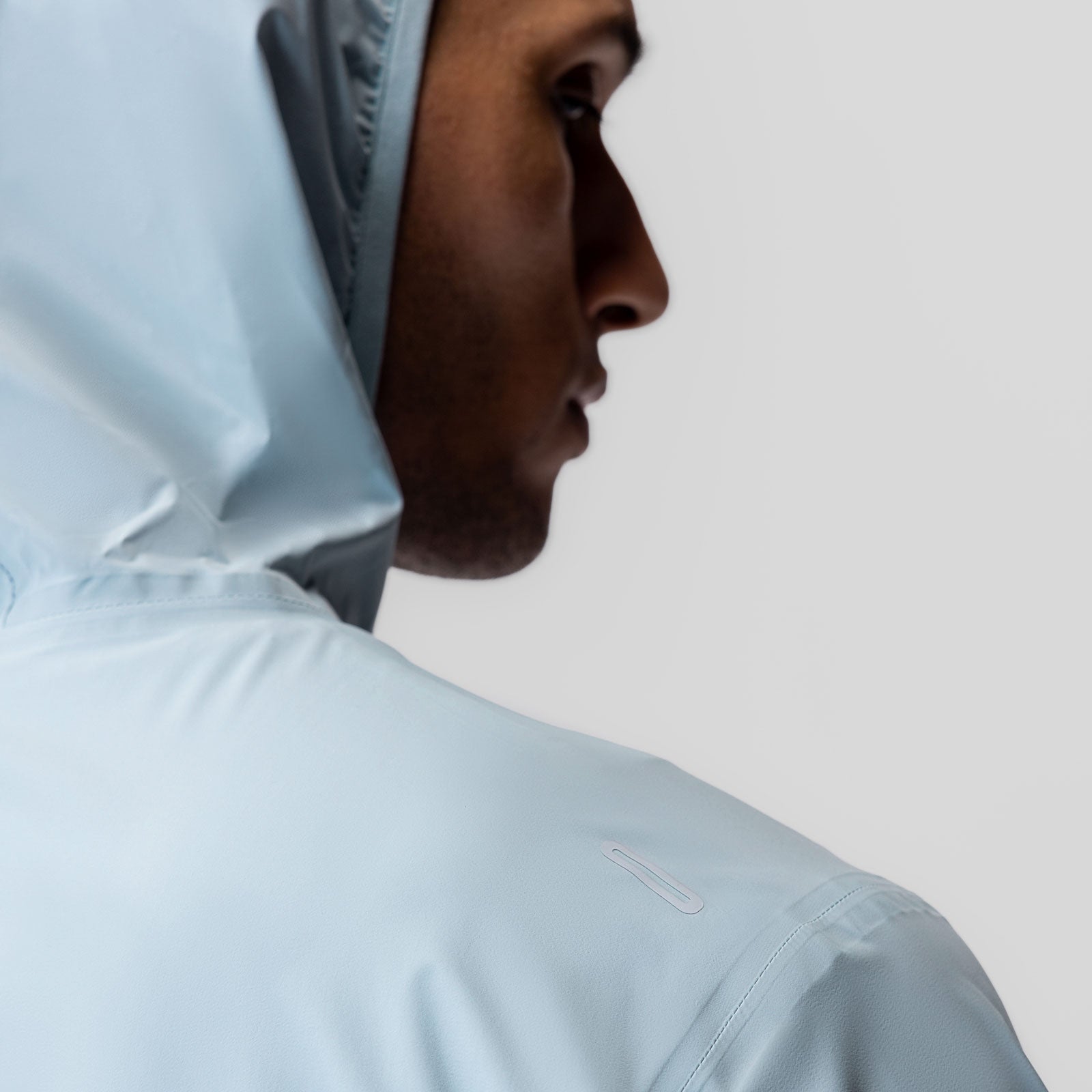 Aerotex Lightweight Windbreaker in light sky, worn by model in profile view