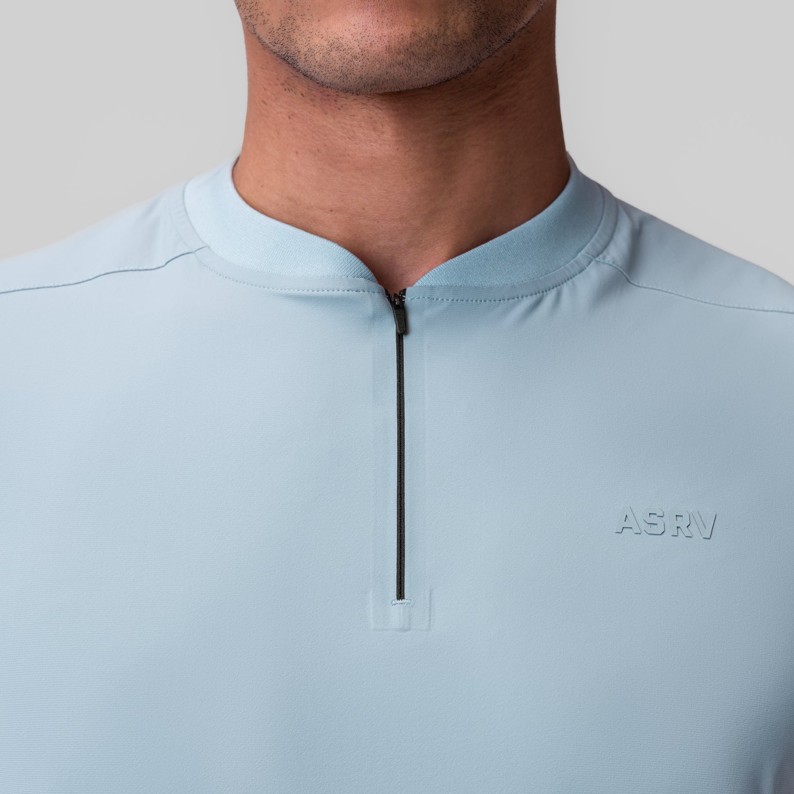 Tetra-Lite® Ice Zip Tee in light sky worn by model, front detail view