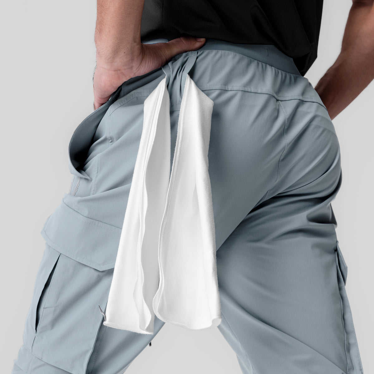 Tetra-Lite Ice Cargo High Rib Jogger in light sky, model holding white towel at waist