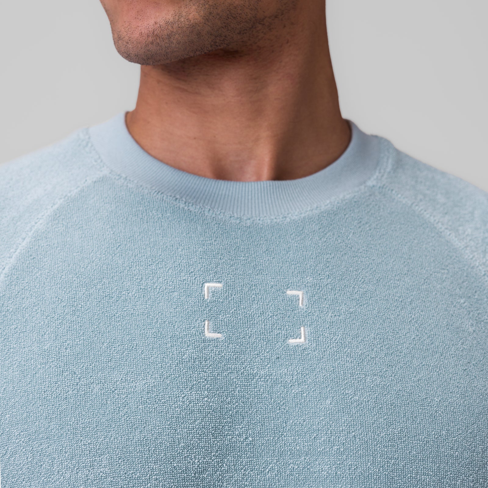 Towel Terry Cutoff sweatshirt in light sky, worn by model, front view
