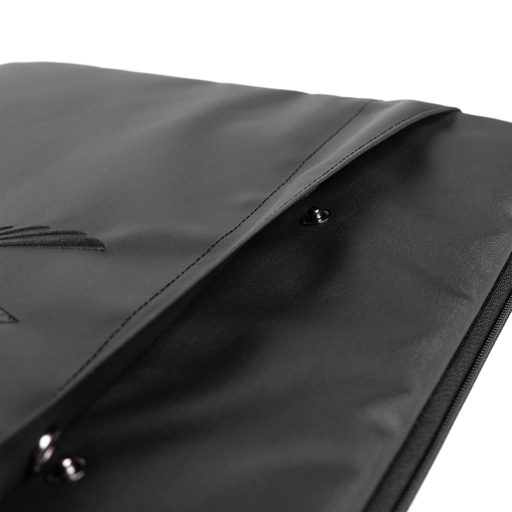 Water resistant padded laptop case in black, detail closeup of zipper and fabric