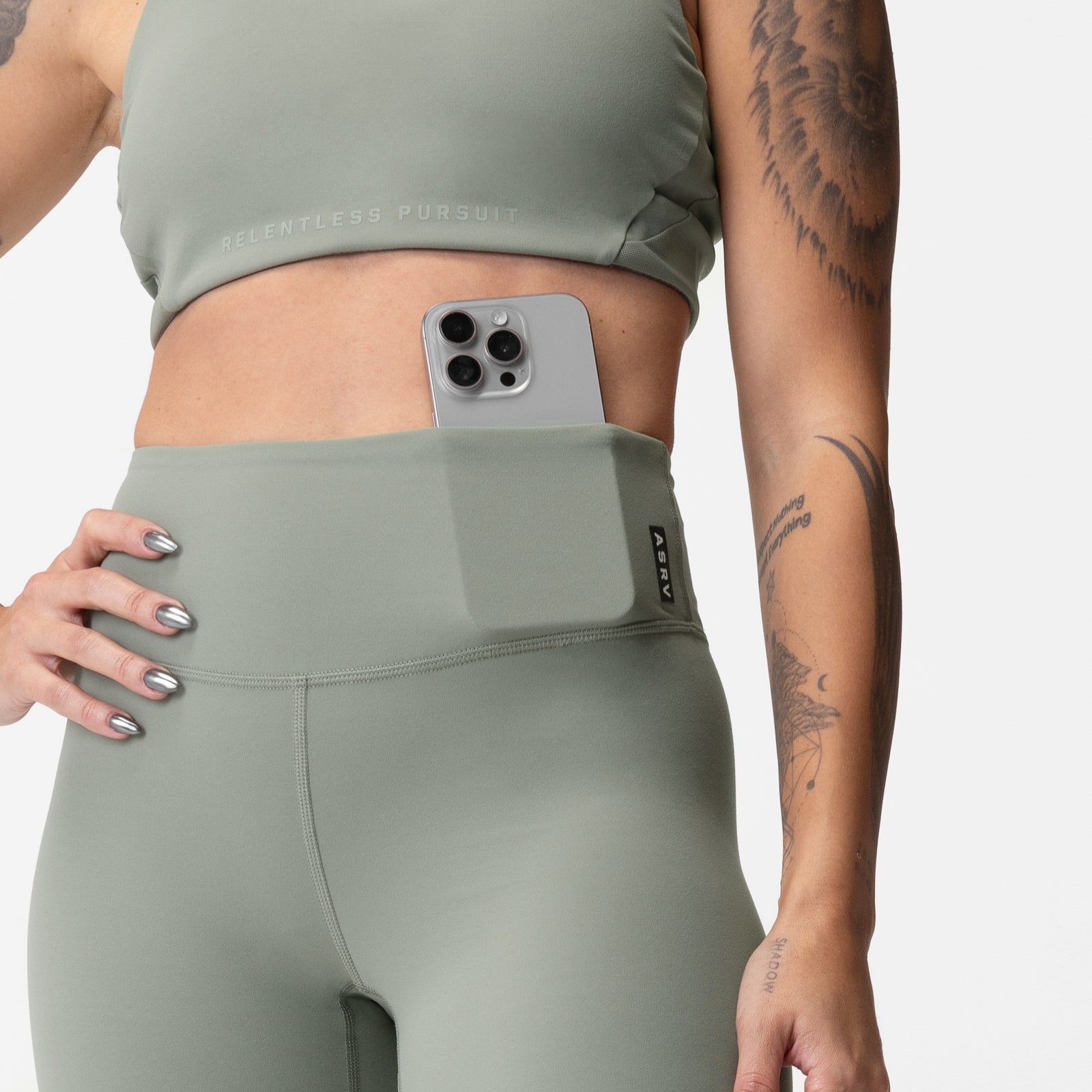 ASRV x Equinox Lycra 7/8 legging in sage, worn with matching crop top, front view
