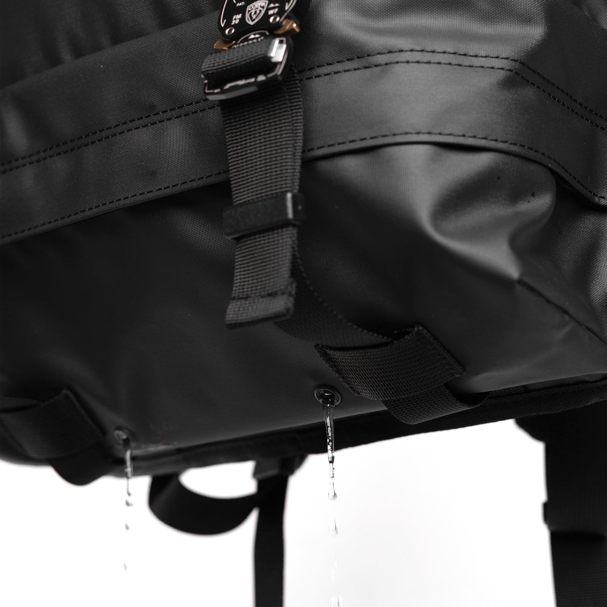 Water Resistant Modular Backpack 16L in black, worn with water droplets visible, detail view