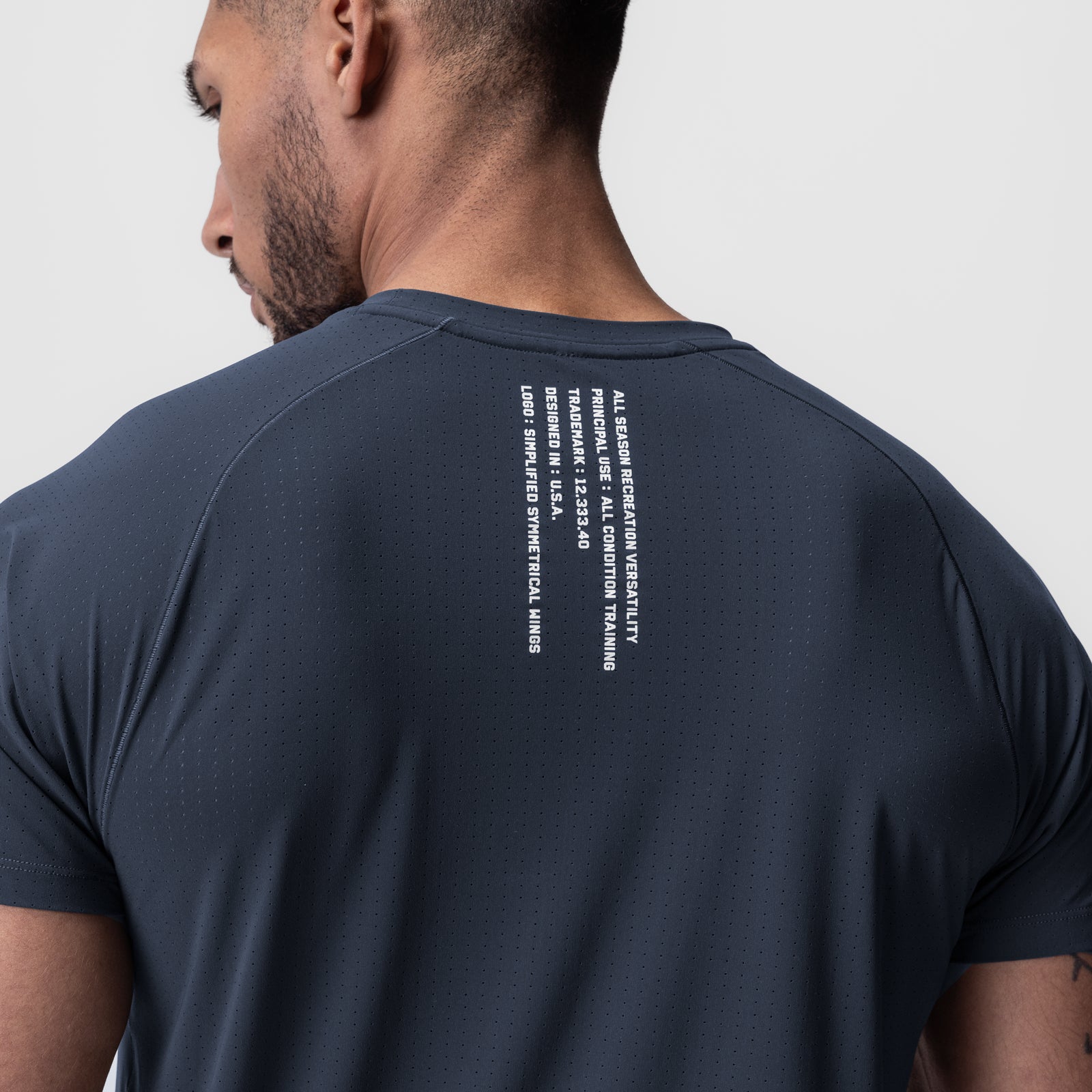 Laser-Vent Established Tee in navy worn by model, back view showing text detail