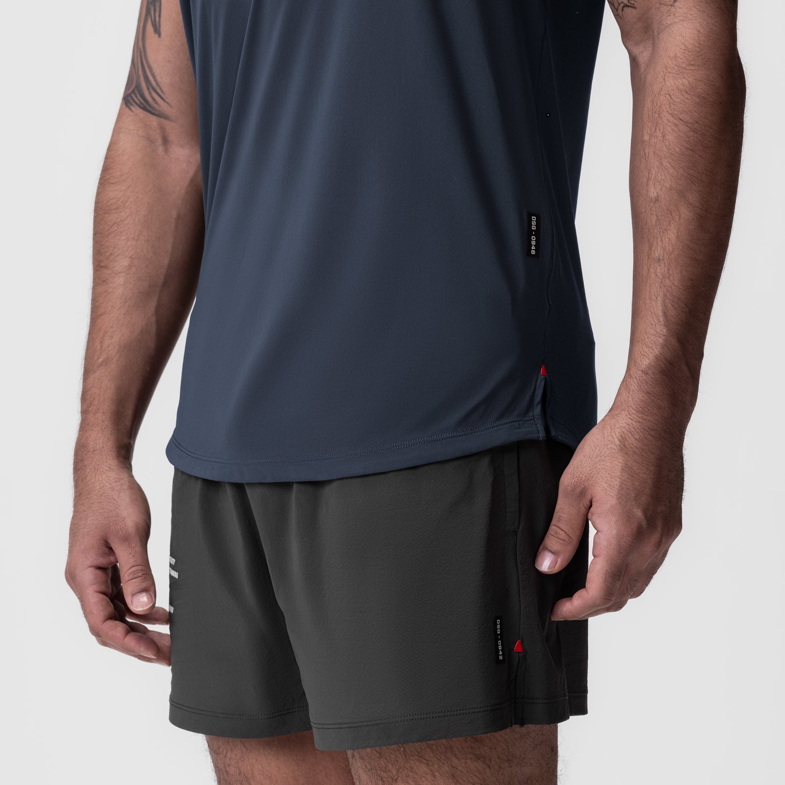 Laser-Vent Established Tee in navy worn with charcoal shorts, side view