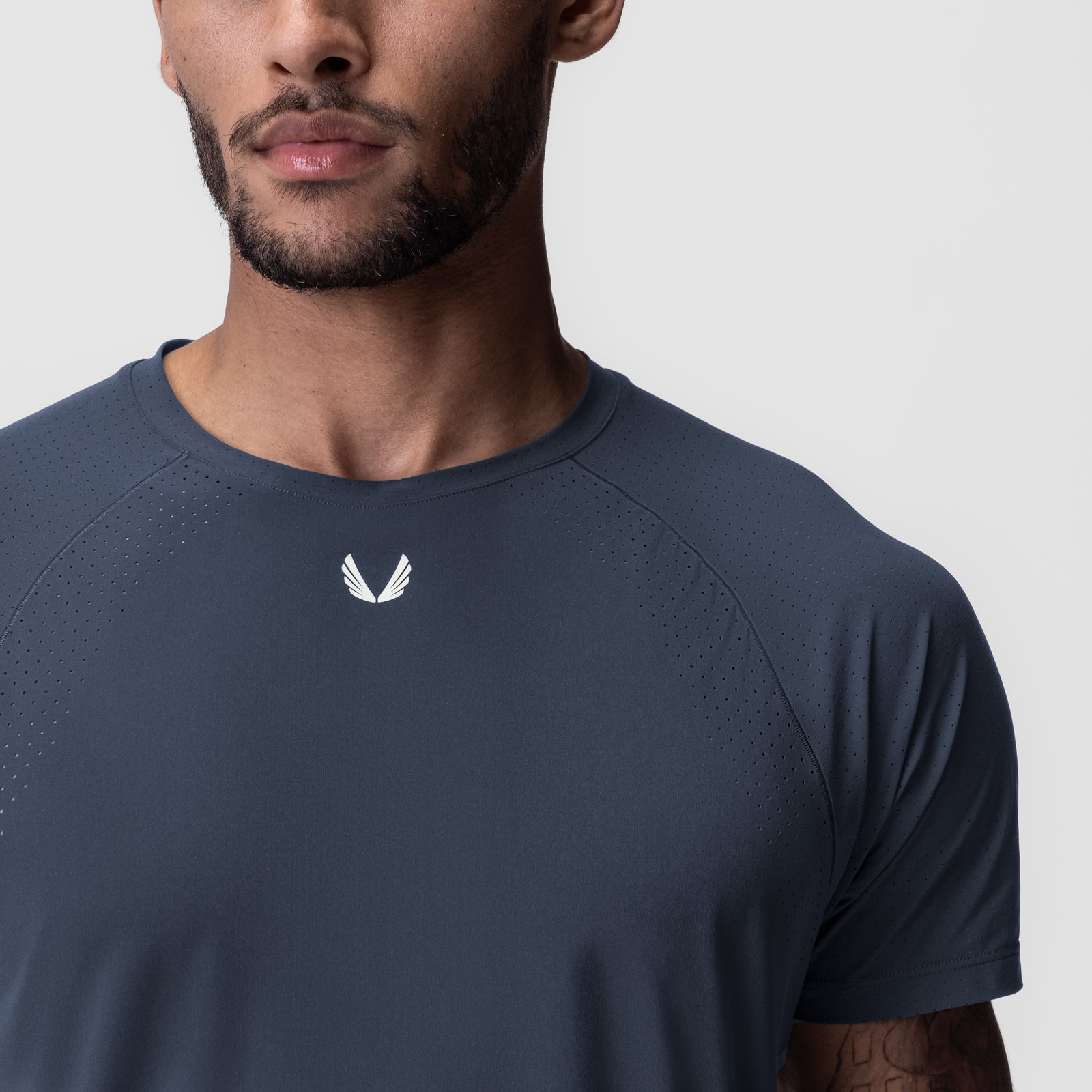 Laser-Vent™ Established Tee in navy worn by model, front view showing small white logo