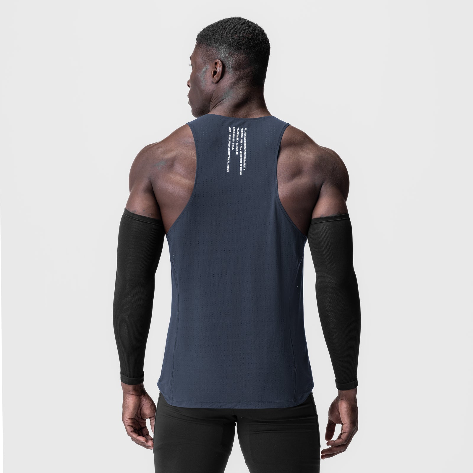 Laser-Vent™ Singlet Tank in navy worn by model from back, showing ribbed texture and back print detail