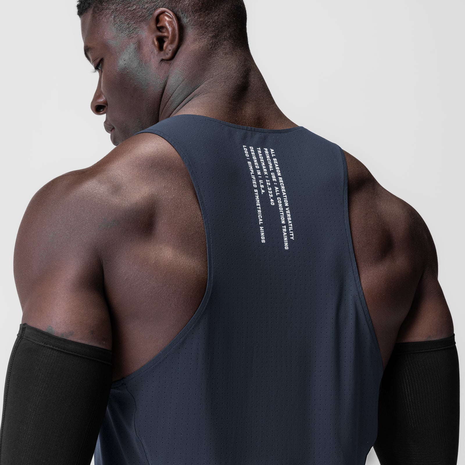 Laser-Vent Singlet Tank in navy worn by male model, back view showing ventilation design