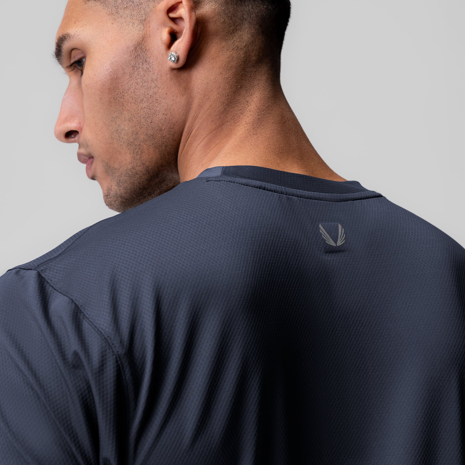 AeroSilver Essential Tee in navy worn by model, back view
