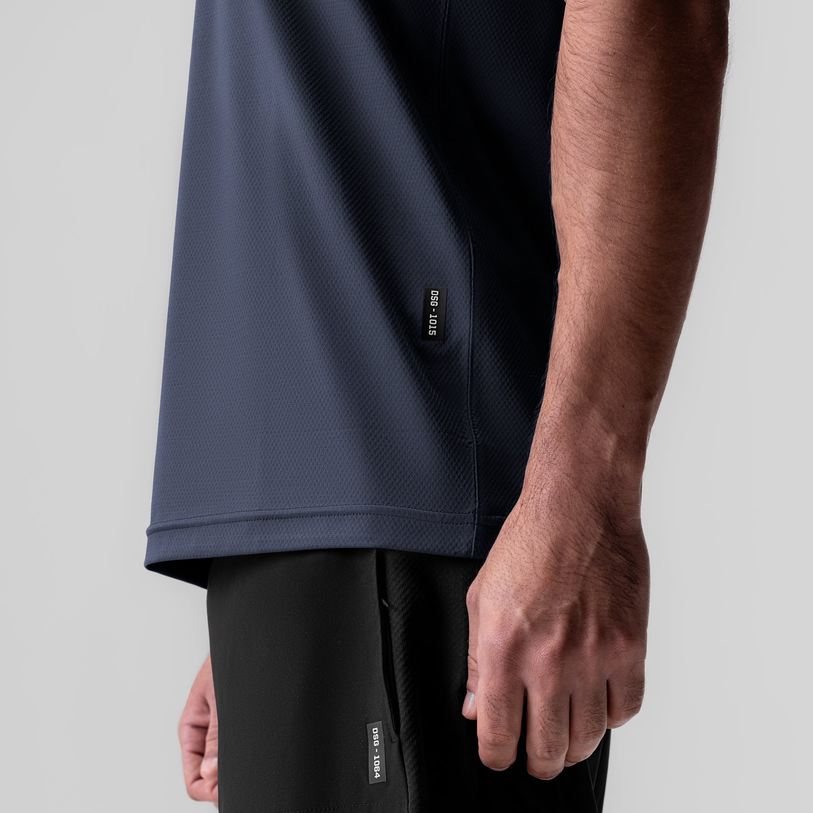 AeroSilver Essential Tee in navy worn by model, side view showing fit and fabric texture