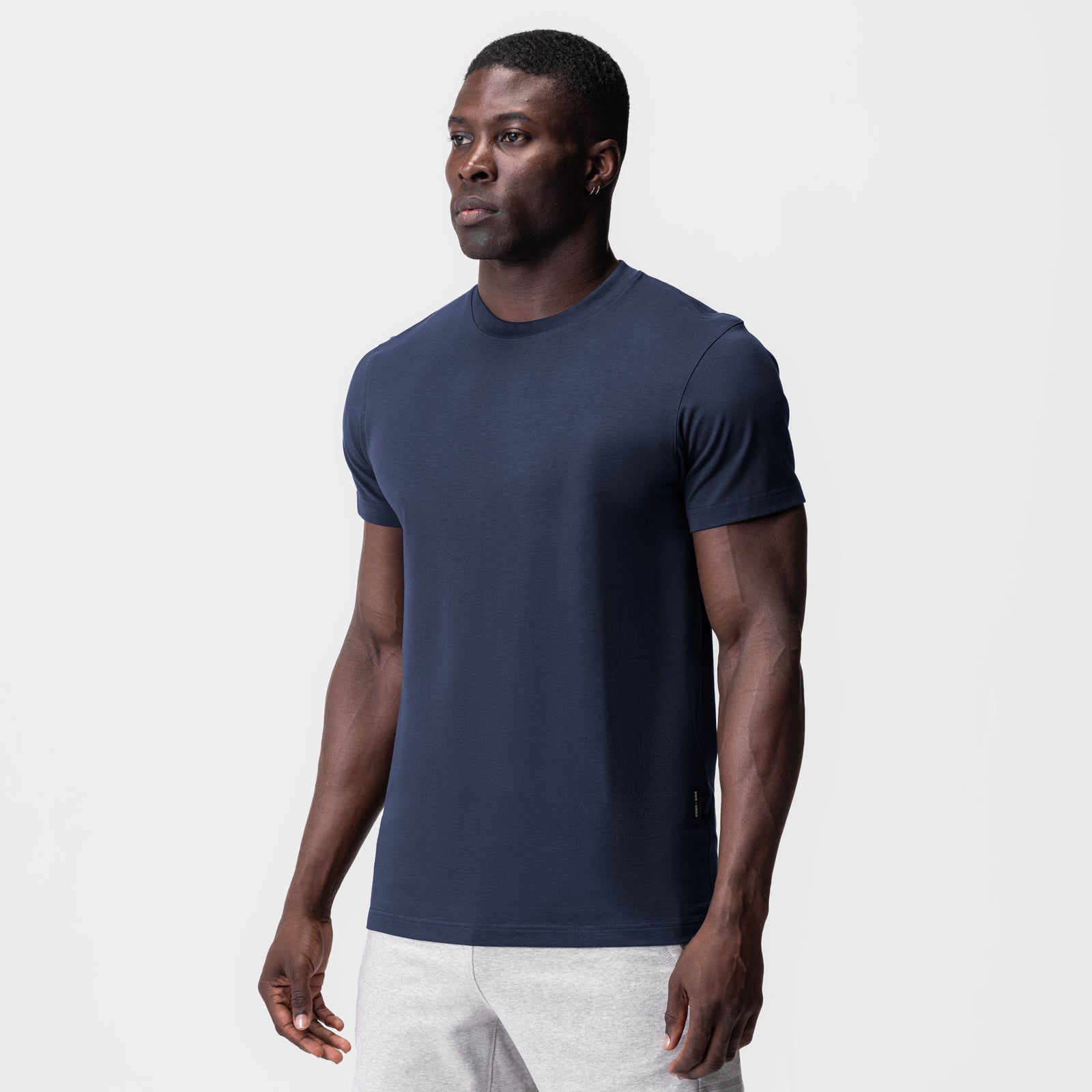 Supima Essential Tee in navy, worn by model in three-quarter front view