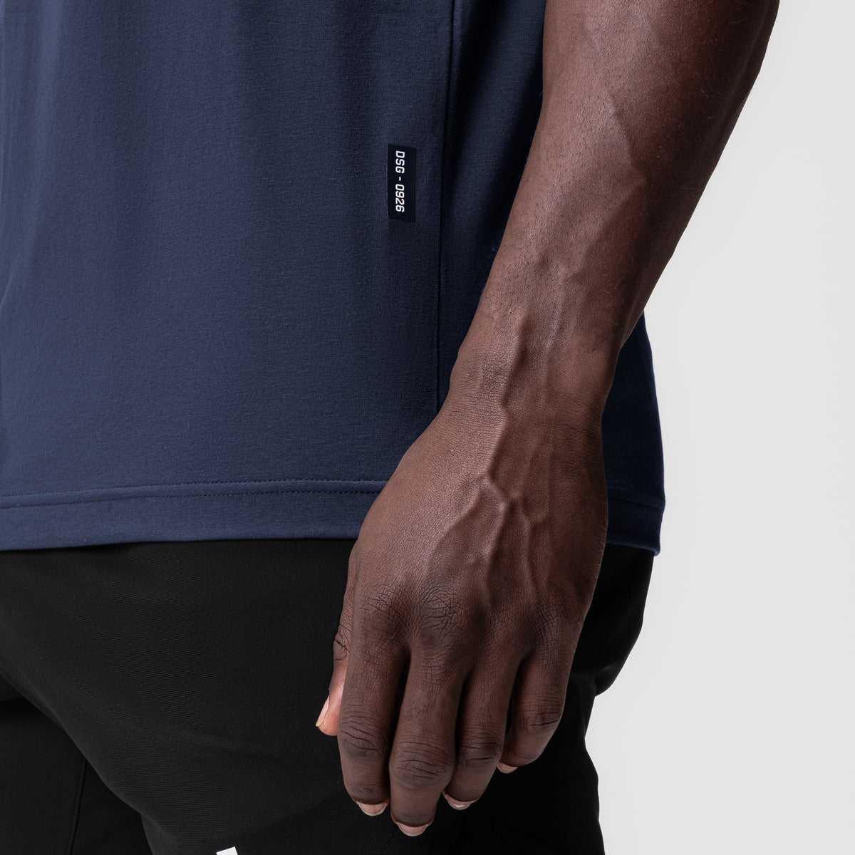 0926. Supima® Muscle Tank in navy worn by model, side detail view
