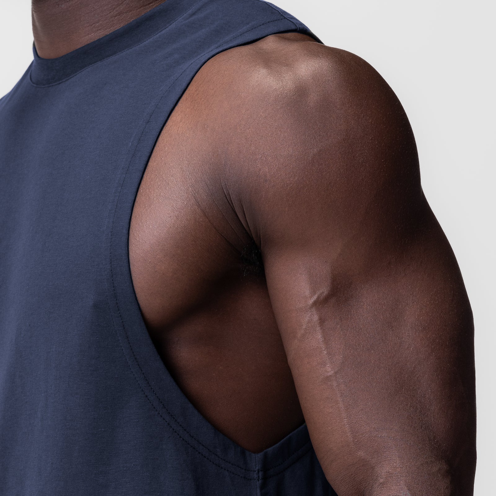 Supima® Muscle Tank in navy, worn by model showing shoulder and arm detail