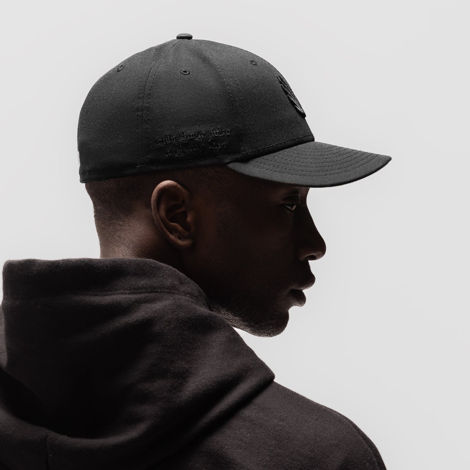 New Era 59Fifty Low Profile Hat in black, modeled in profile view