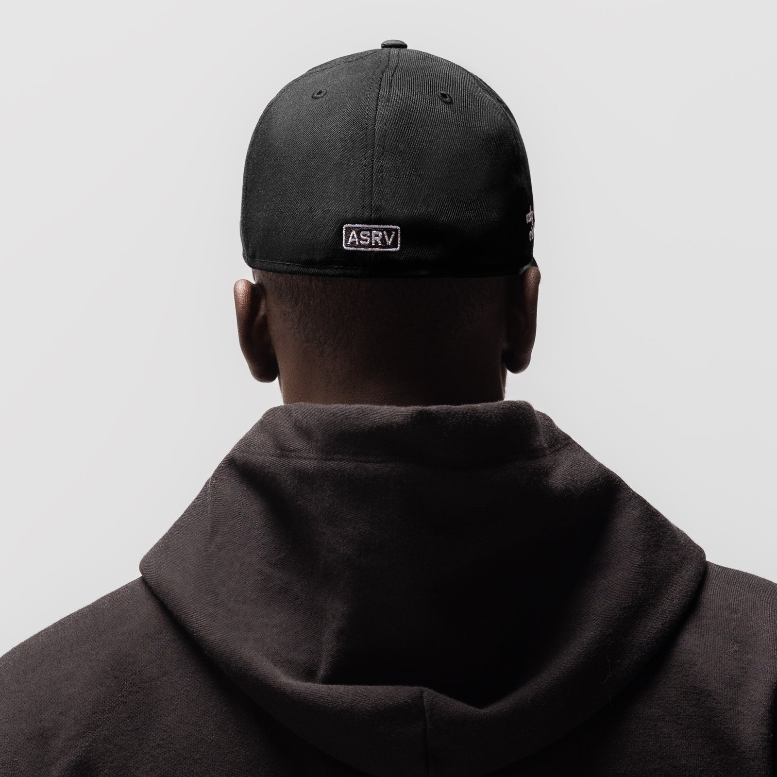 Black New Era 59Fifty cap with ASRV patch, worn by model from behind
