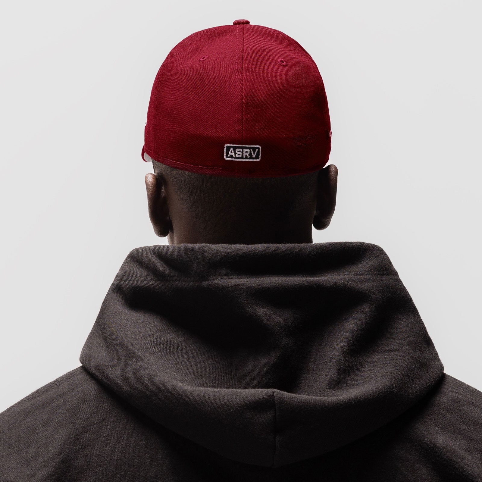 Crimson New Era 59Fifty Low Profile Hat worn by model from back, showing ASRV label