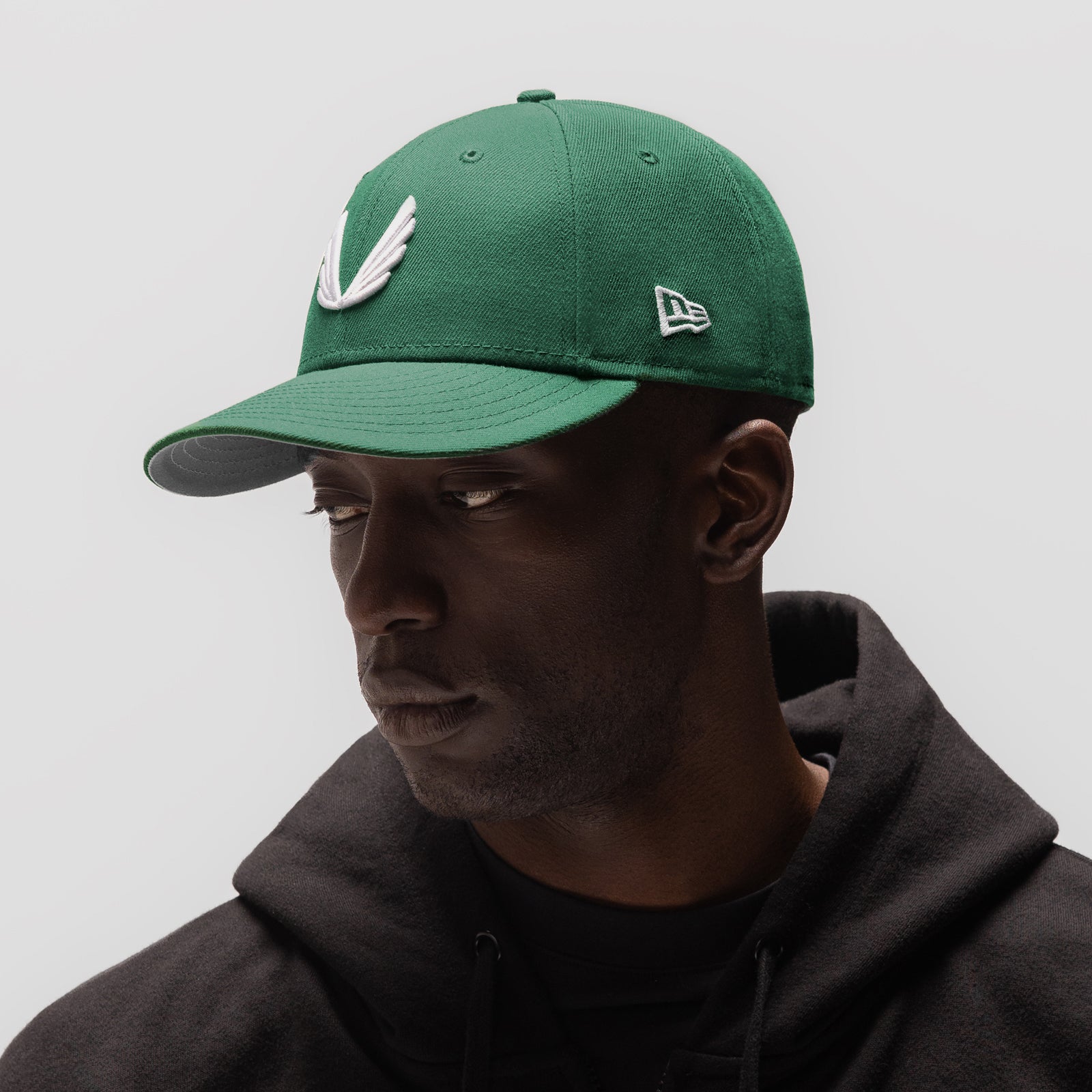 New Era 59Fifty Low Profile Hat in emerald green with white wings logo, worn by model