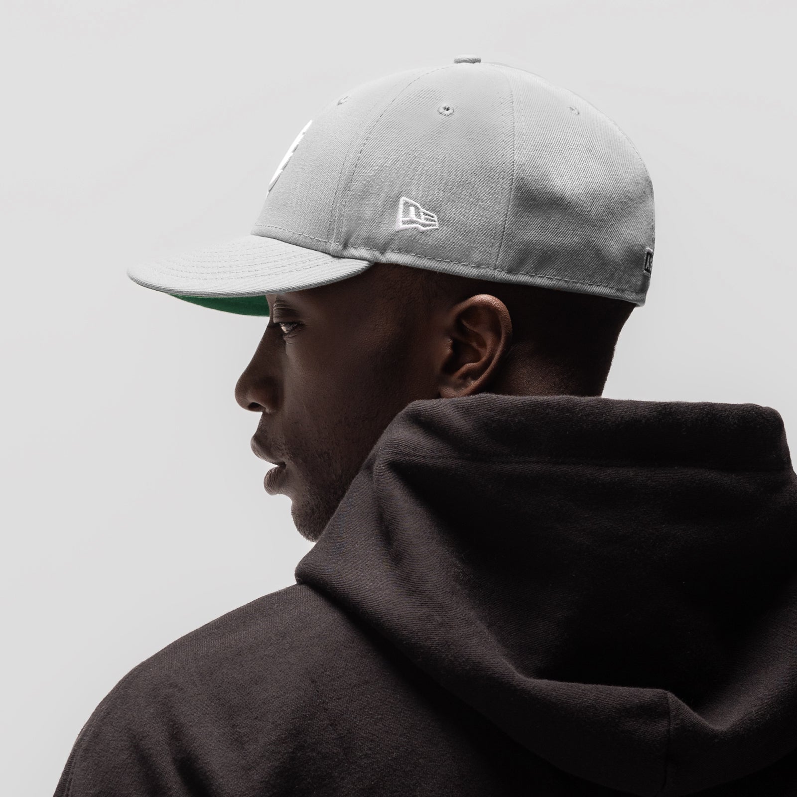 New Era 59Fifty Low Profile Hat in grey and white, worn by model in profile view