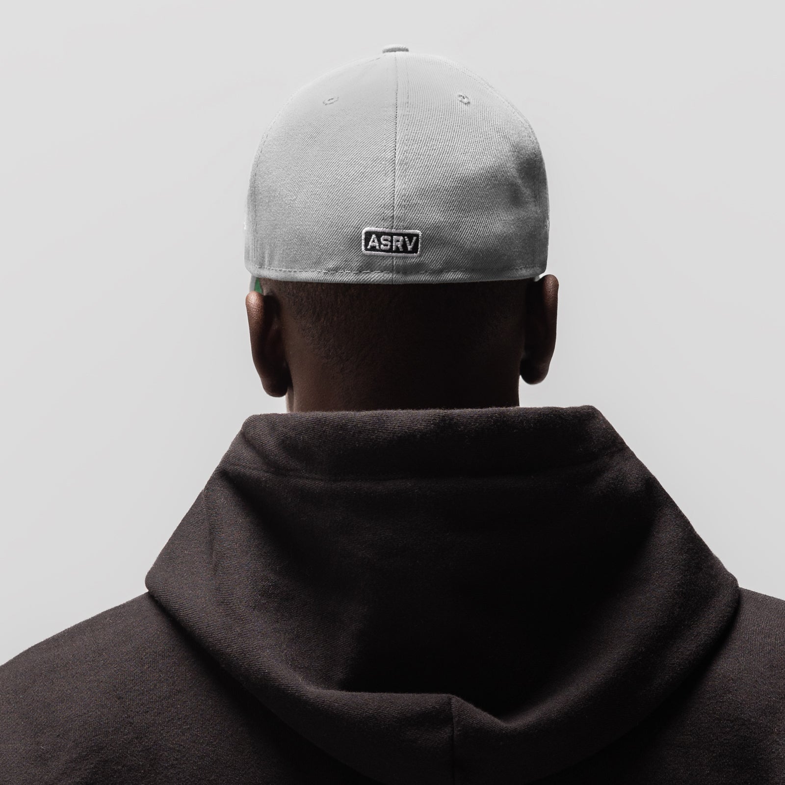 New Era 59Fifty Low Profile Hat in grey, worn from back view with black hoodie