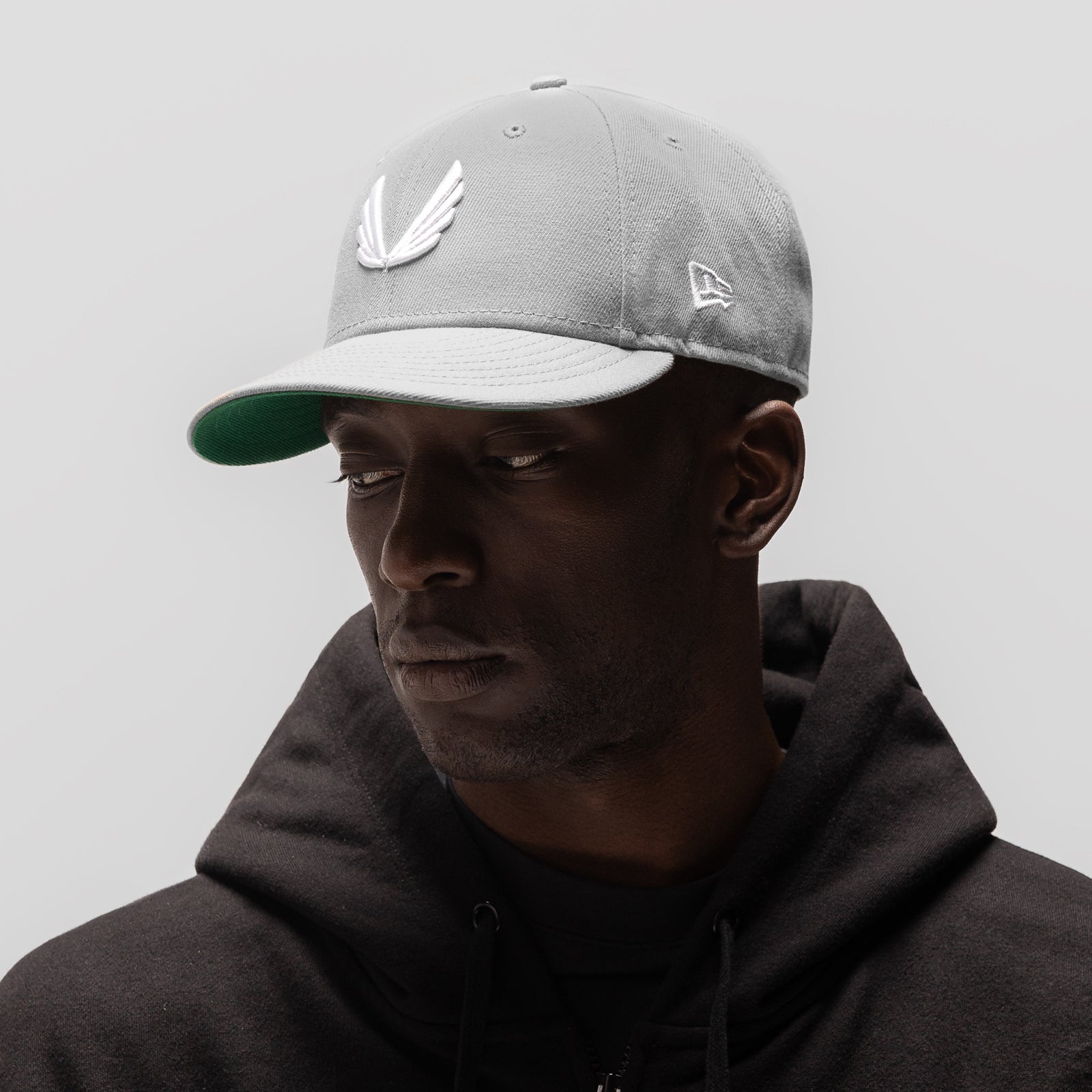 New Era 59Fifty Low Profile Hat in grey/white with wings logo, worn by model