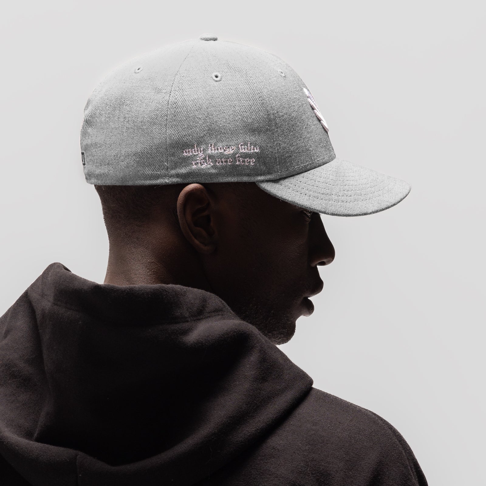 New Era 59Fifty Low Profile Hat in heather grey with white embroidery, side profile on model