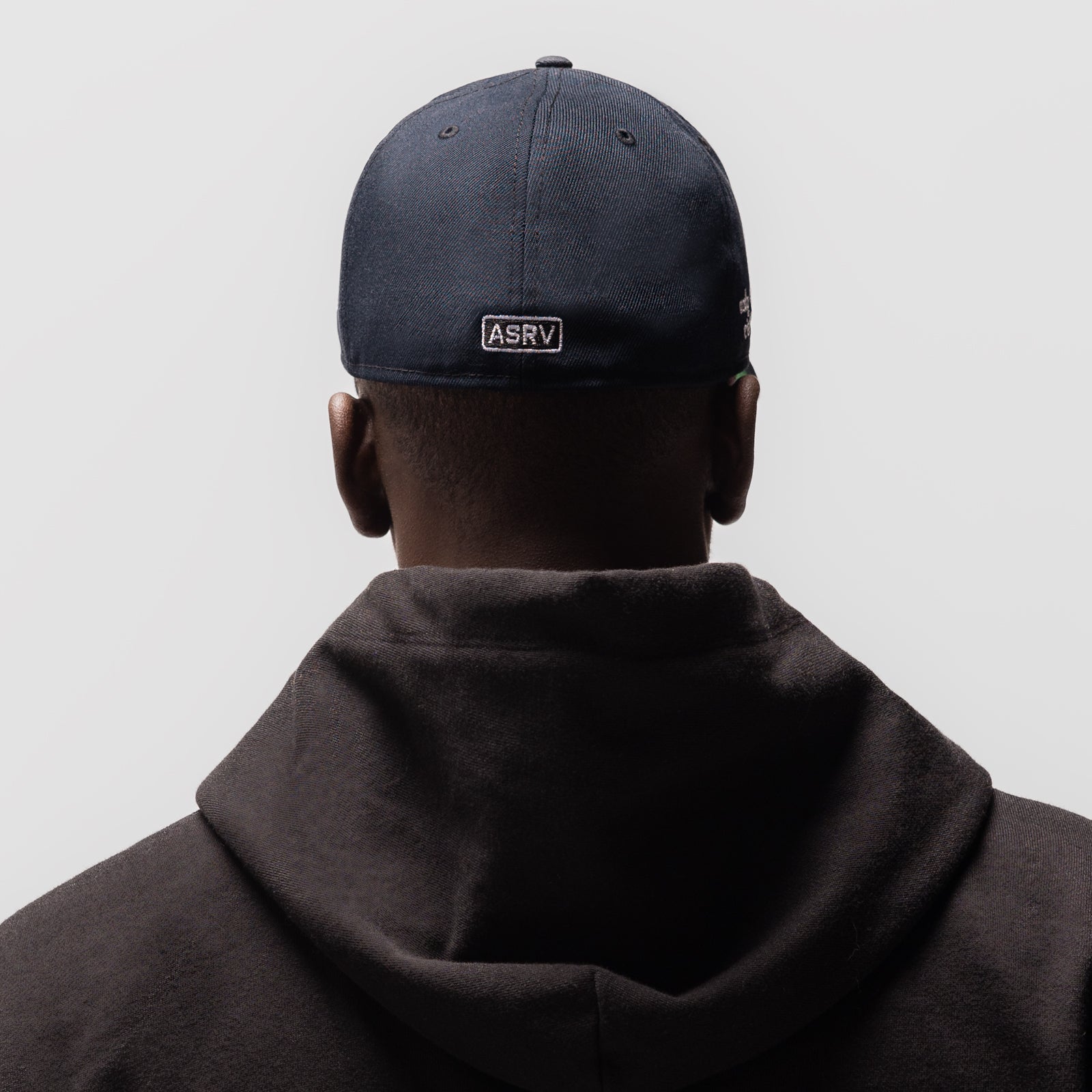 Navy New Era 59Fifty Low Profile Hat worn from behind, showing ASRV patch