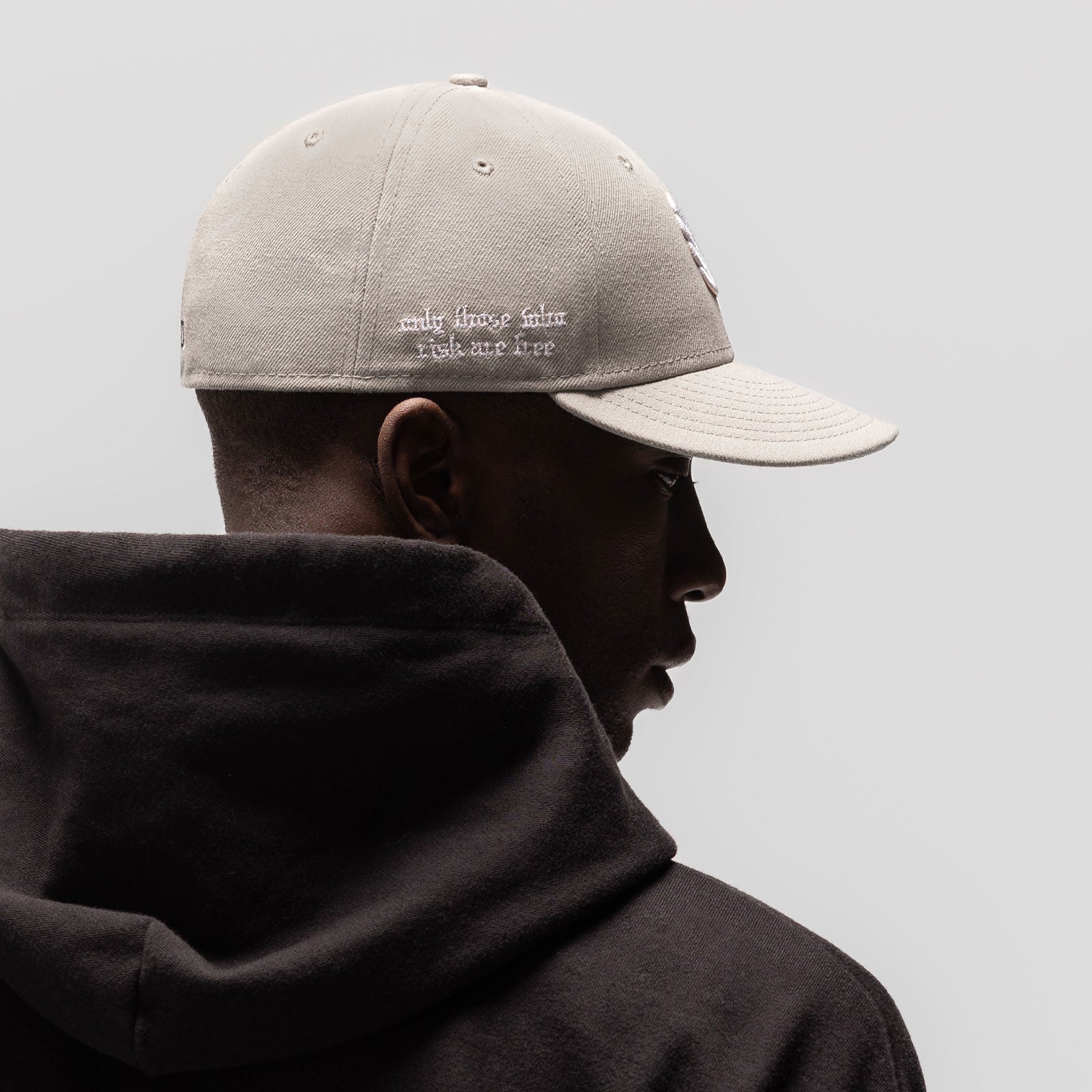 New Era 59Fifty Low Profile Hat in stone, worn by model in profile view