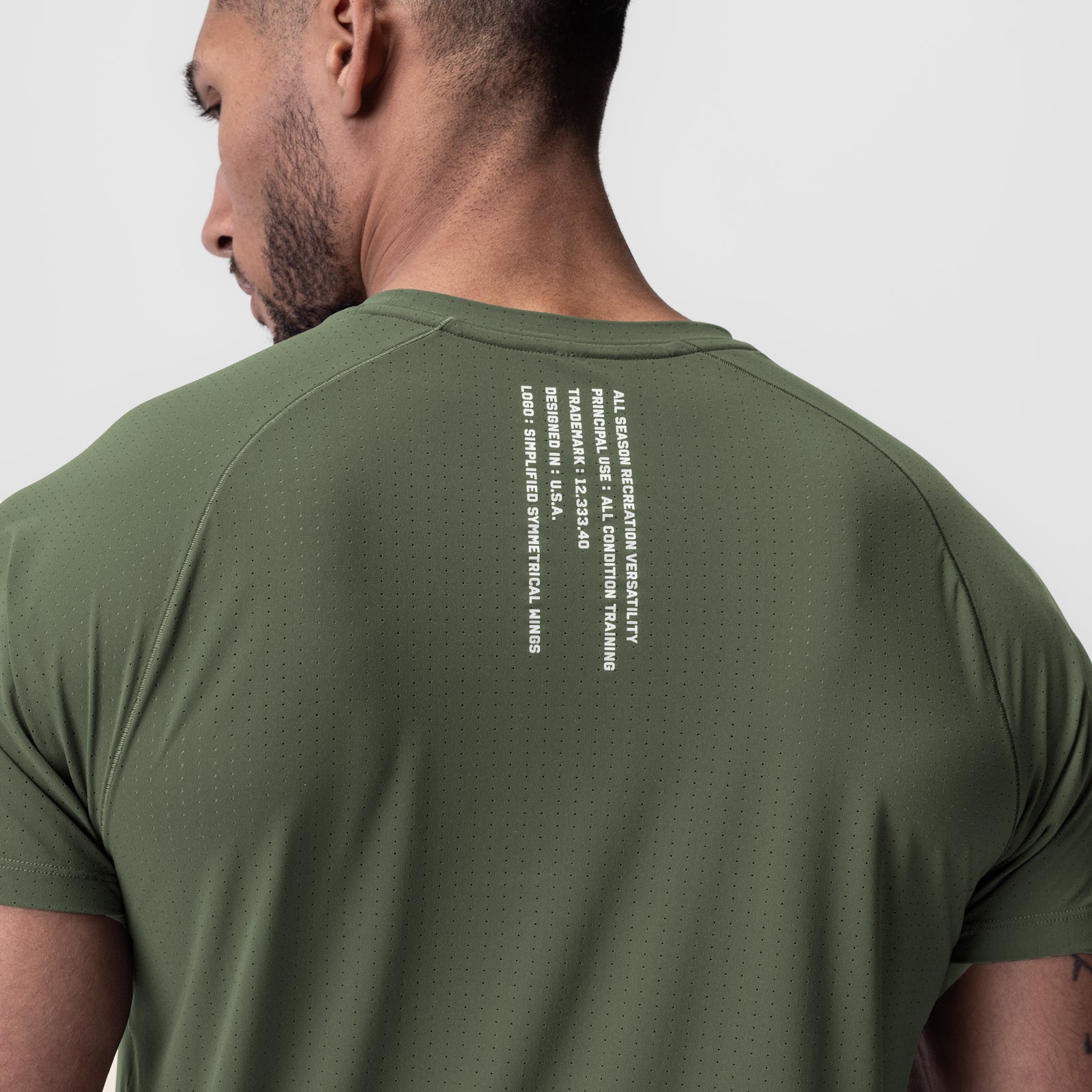 Laser-Vent Established Tee in olive worn by model, back view showing text detail