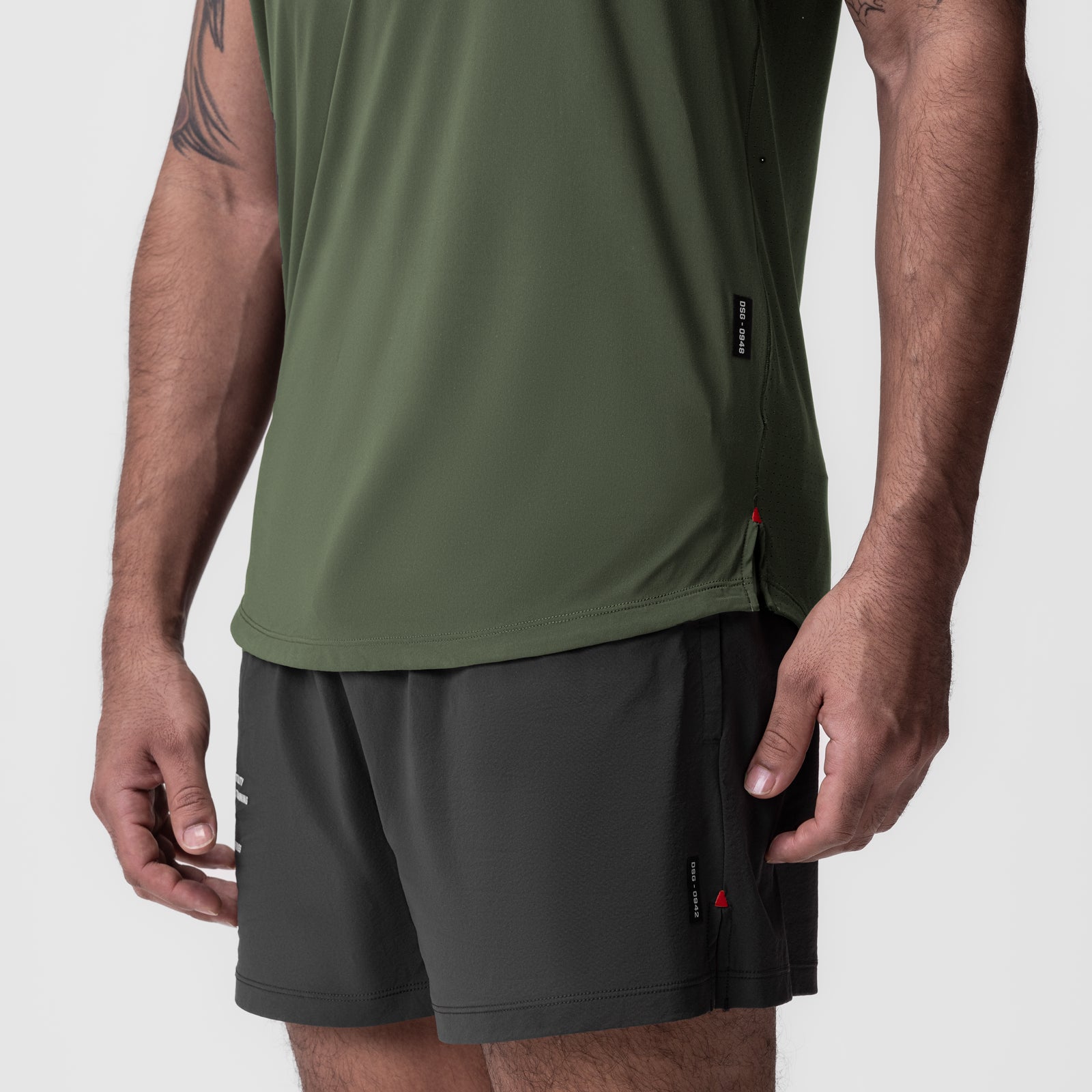 Laser-Vent Established Tee in olive worn with black shorts, side view on model