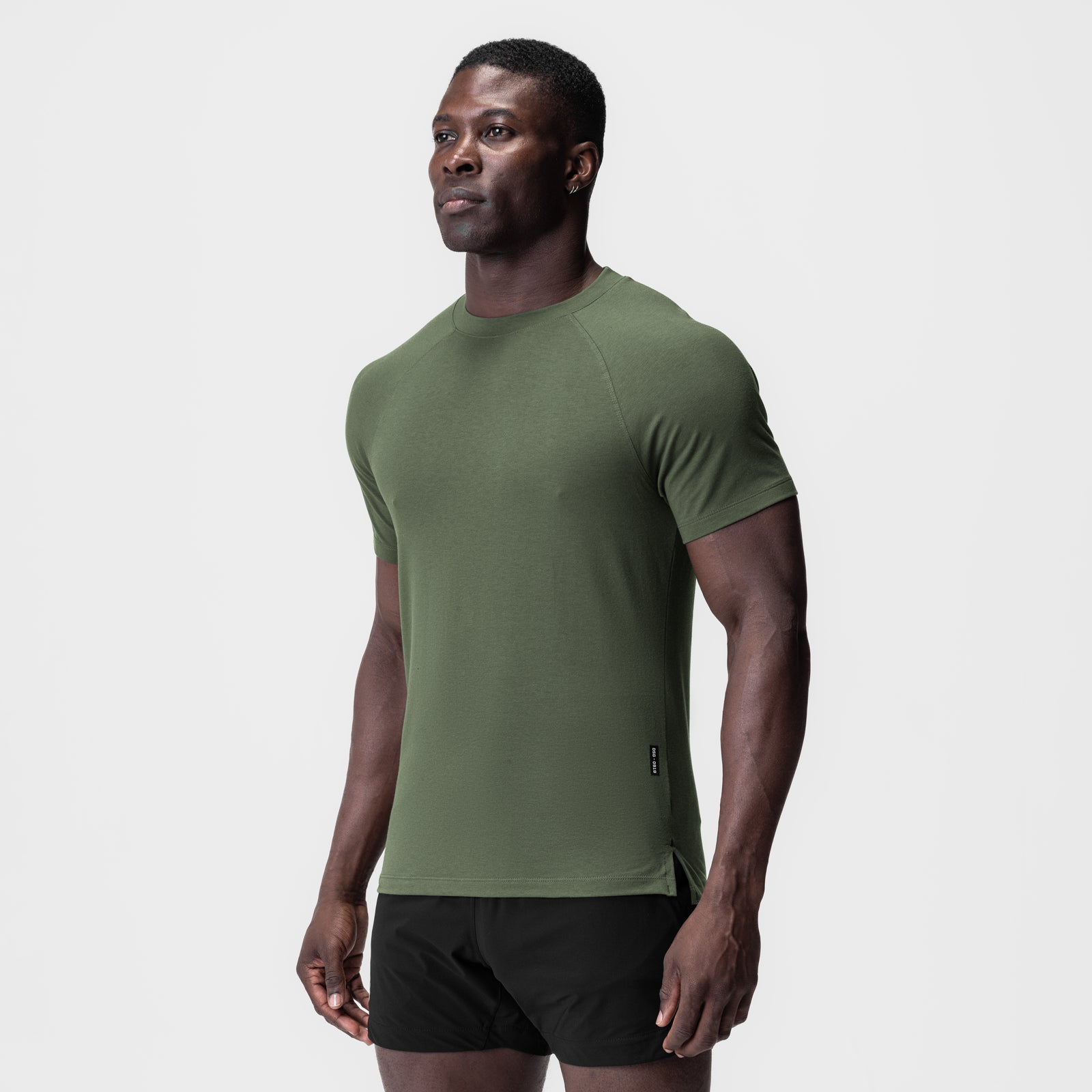 Olive green Supima® fitted tee on model, front three-quarter view