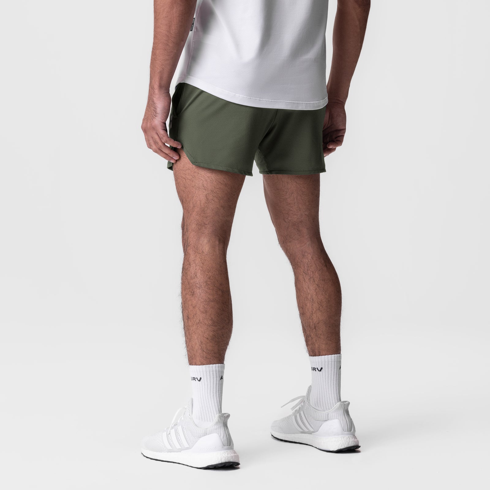 AeroSilver 5" Linerless Short in olive, worn with white socks and sneakers, back view