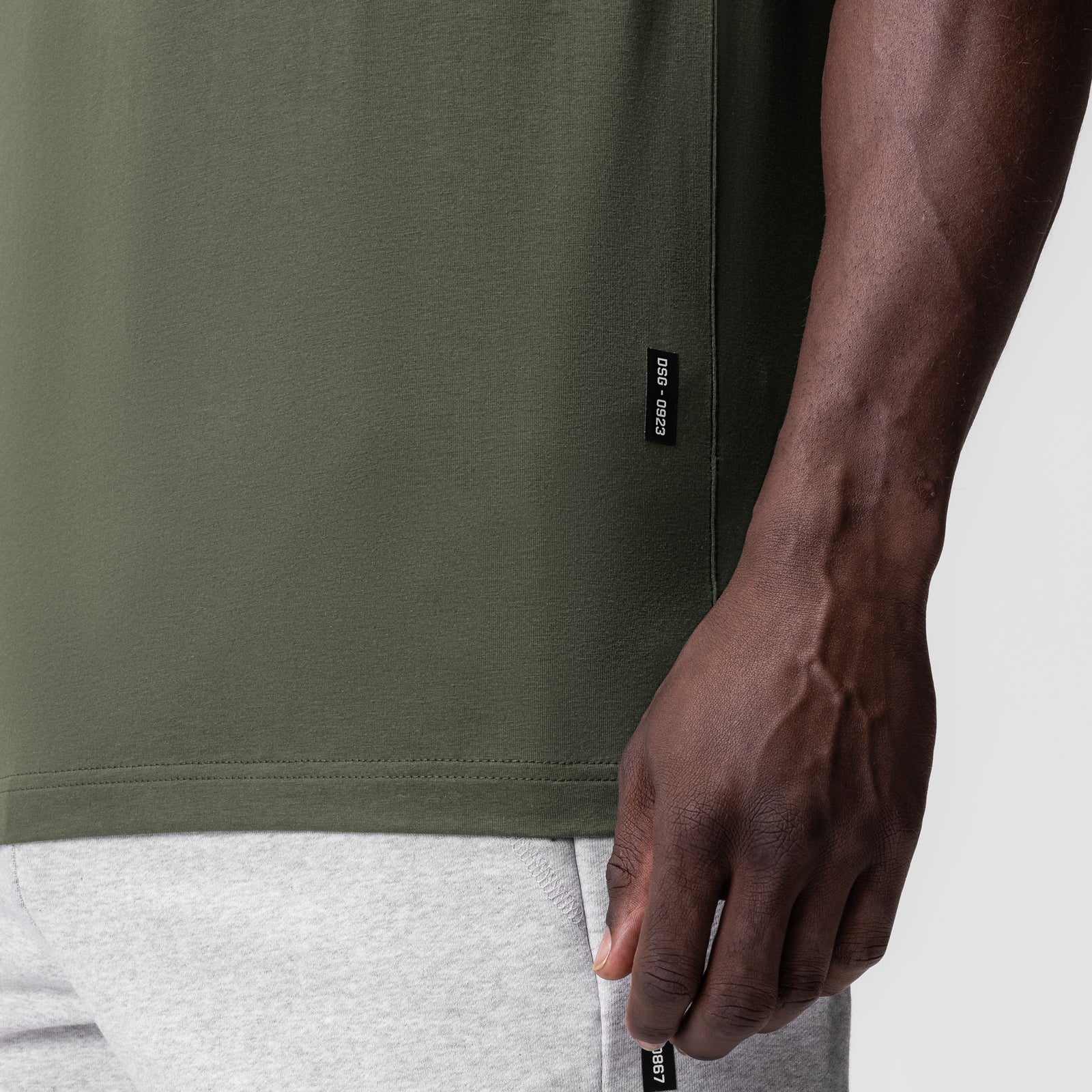 Supima Essential Tee in olive worn by model, side view showing fit