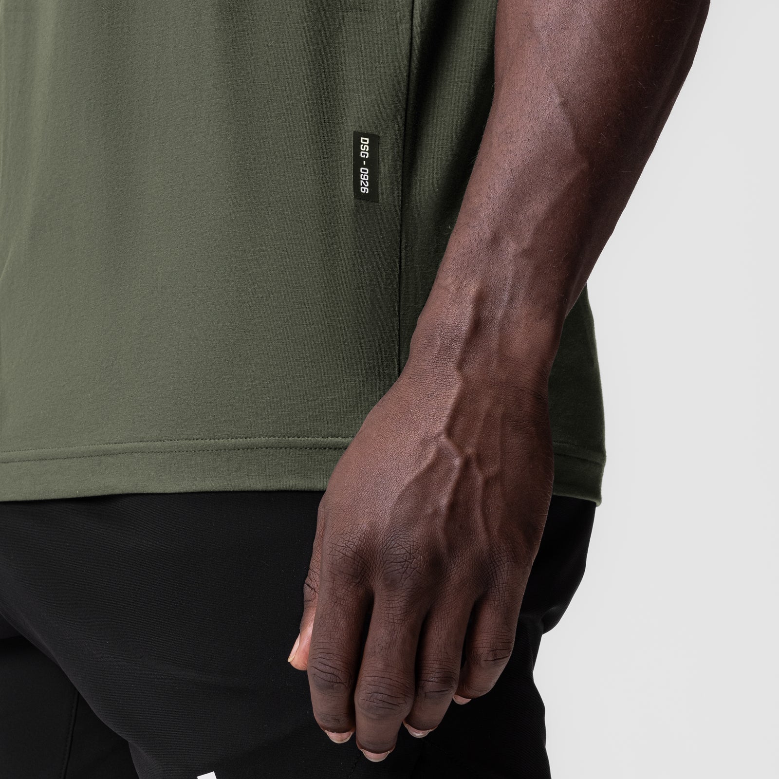 Olive Supima® Muscle Tank worn by model, side view showing fit and drape