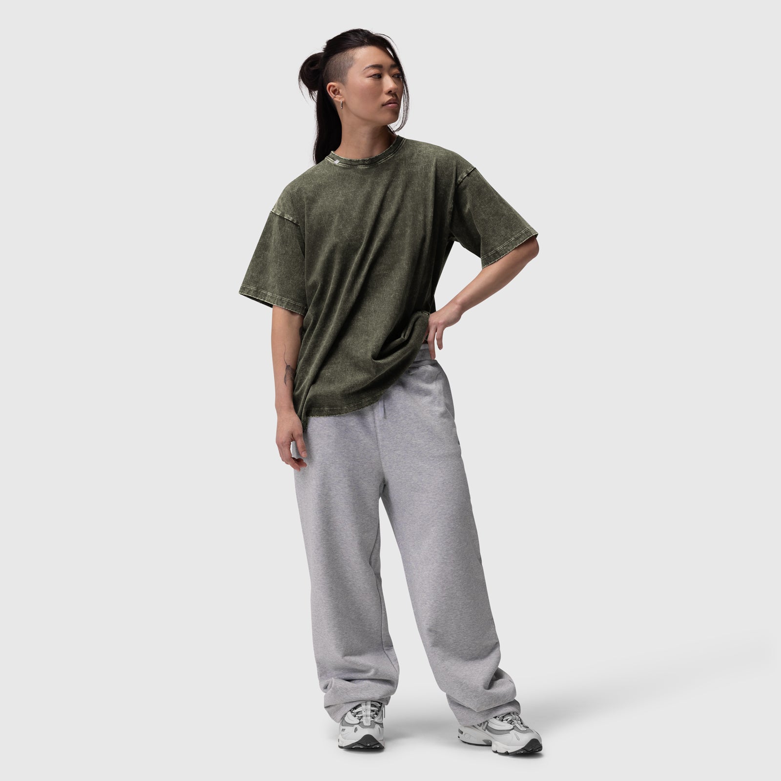 Distressed Relaxed Tee in olive worn with gray joggers, front view