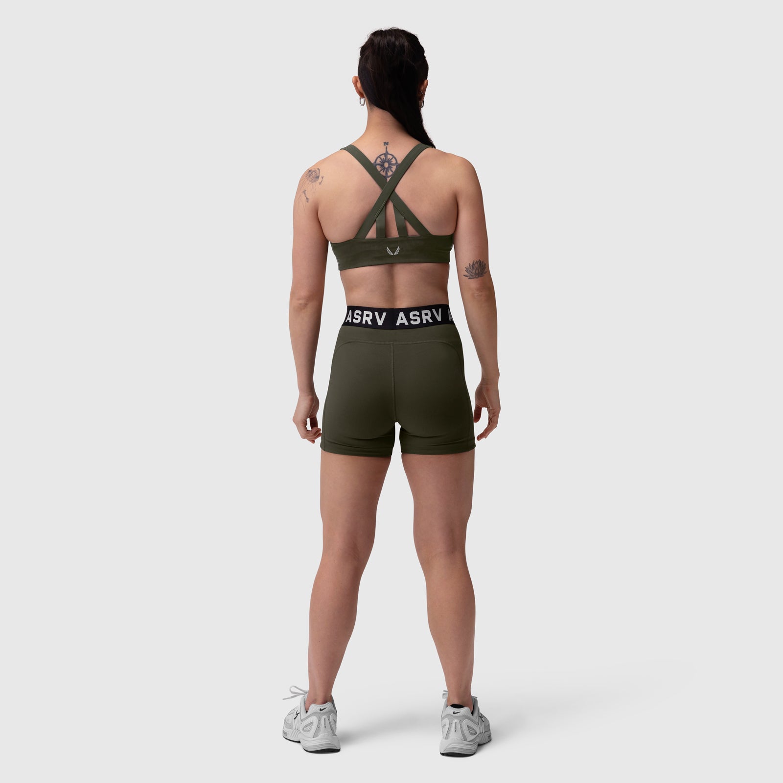 W027 Lycra Ribbed Short in olive, worn by model from behind, showing cross-back sports bra and waistband detail
