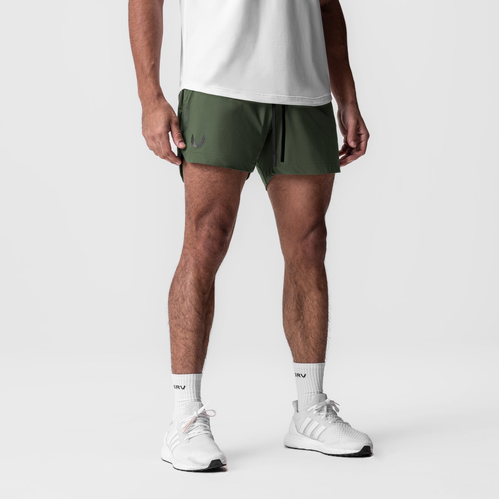 Tetra-Lite 5" Linerless Short in olive, worn by model with white socks and sneakers