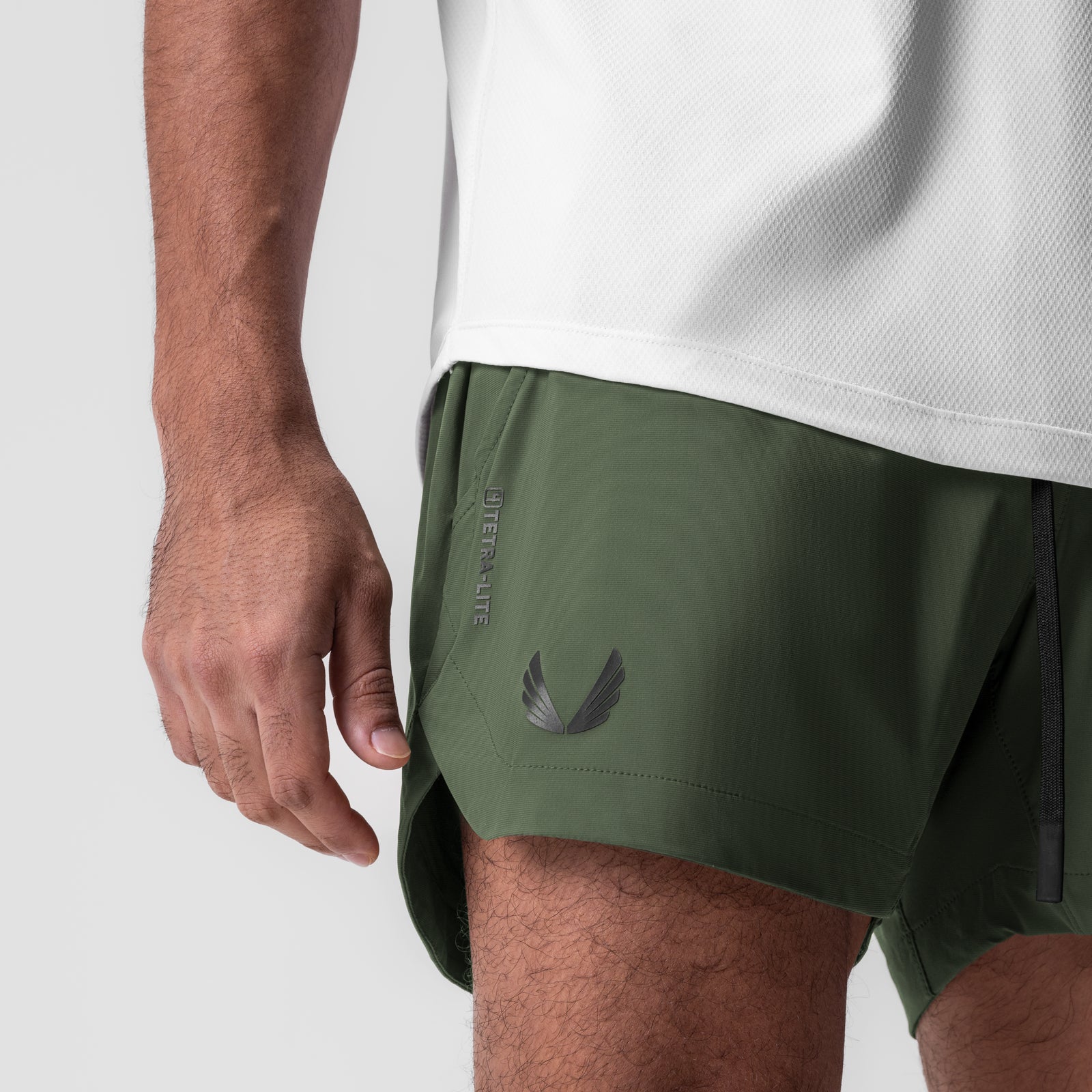 Tetra-Lite 5" Linerless Short in olive with black wings logo, worn by model, side view