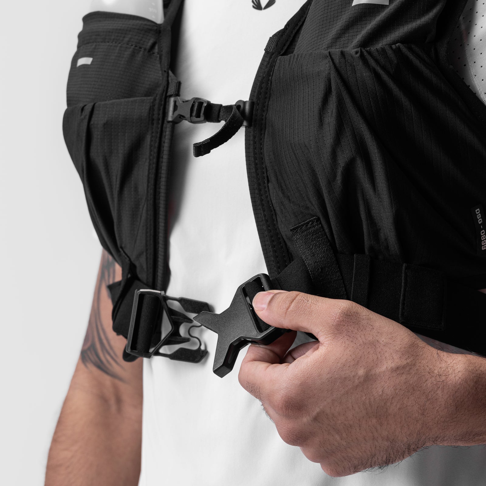 2-in-1 Packable Run Vest in Black, worn and fastened detail closeup