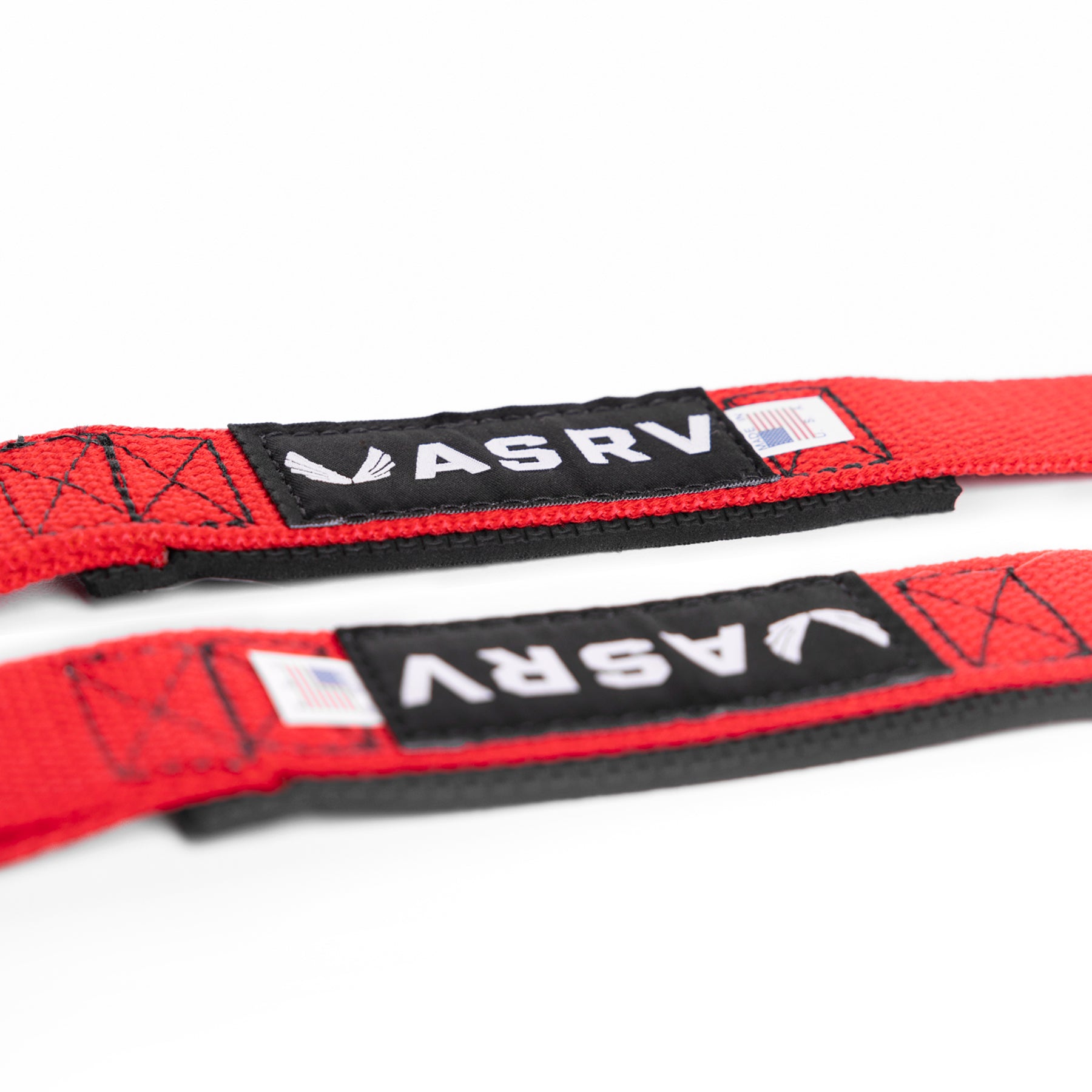 flatlay of Padded Lifting Straps in Akira Red with black labels, overhead view