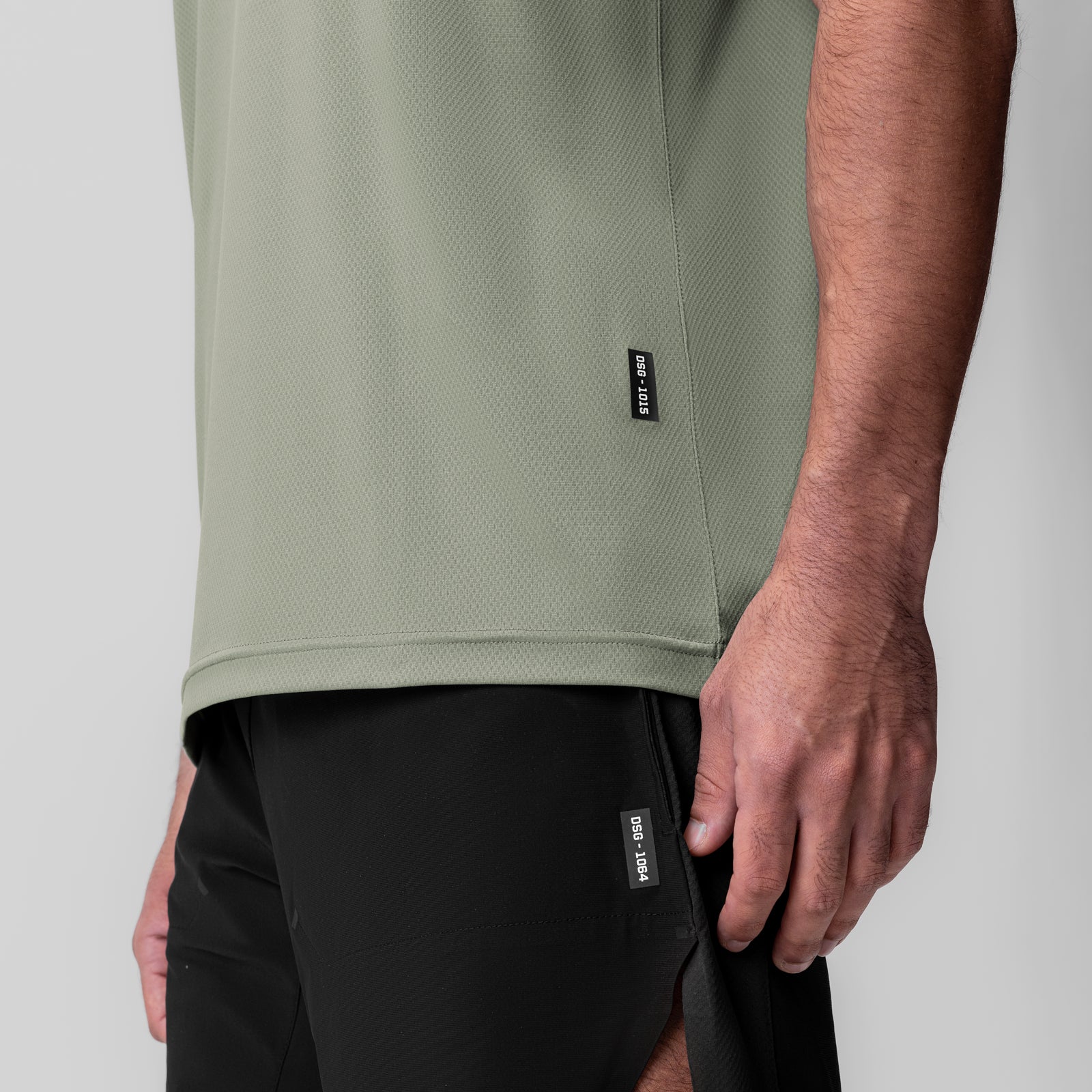 AeroSilver Essential Tee in sage, worn by model showing side view and fit