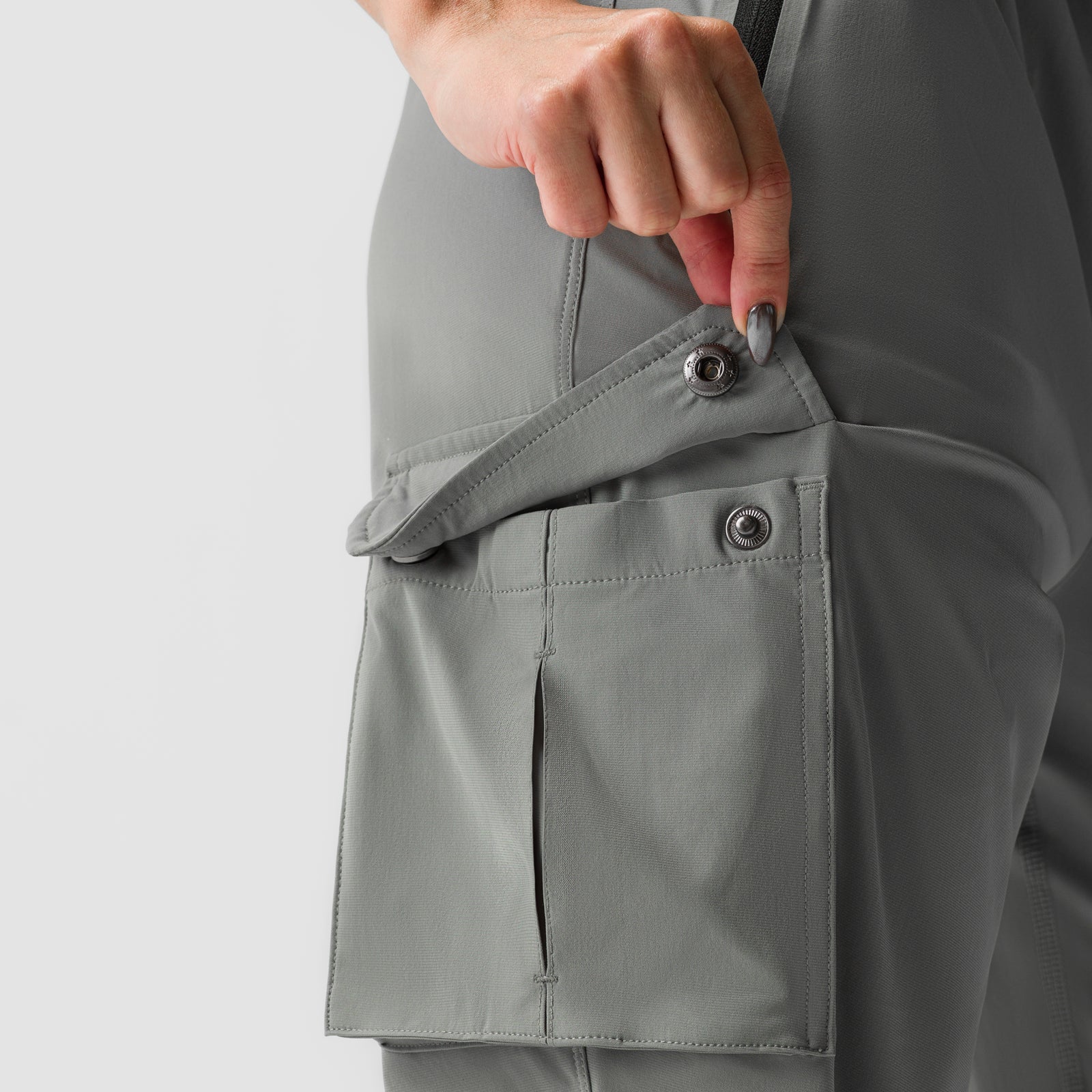 Sage Tetra-Lite cargo jogger worn by model, showing detail of side cargo pocket with snap closure
